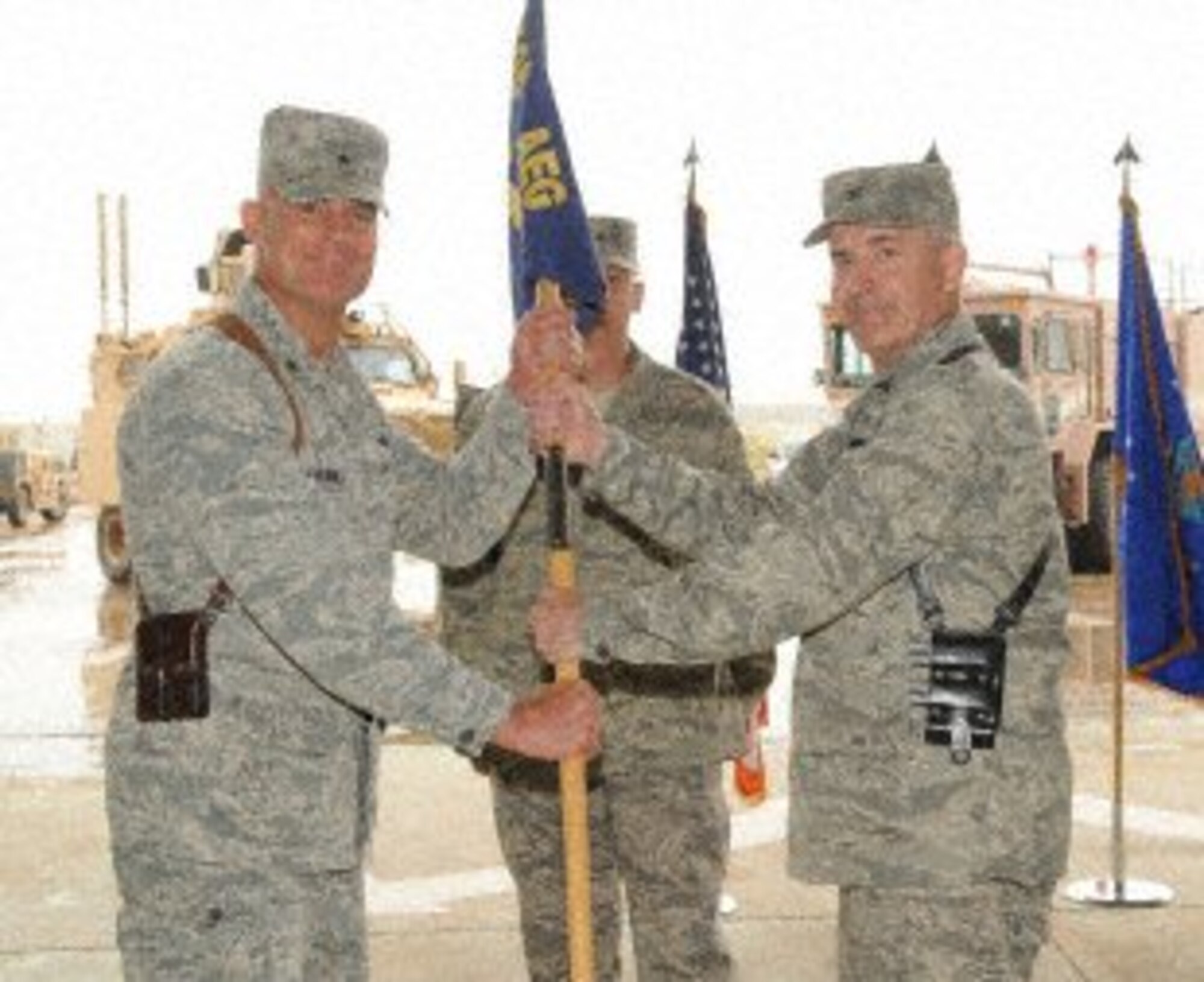Brig. Gen. Craig Franklin, 332nd Air Expeditionary Wing commander, passes a guidon to Col. Steven Slick, 506th Air Expeditionary Group commander, during the 506 AEG change of command ceremony at Kirkuk Regional Air Base, Iraq, April. 22. Slick replaced Col. Leonard Dick as the group commander. The ceremony was attended by Iraqi air force members, mission partners from the Iraq Training and Advisory Mission – Air Force, and the men and women of the 506th AEG.