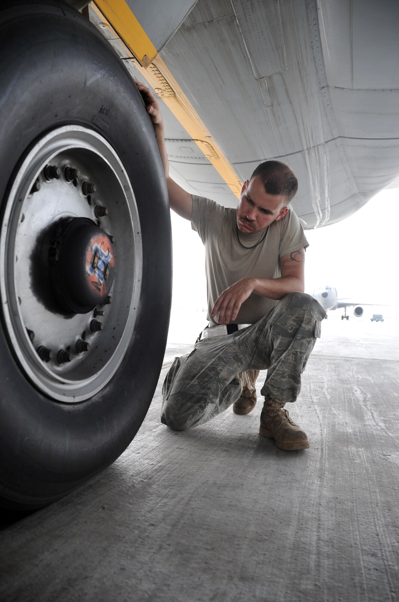Airman 1st Class Brian Welch, KC-10 Extender crew chief with the 380th Expeditionary Aircraft Maintenance Squadron Extender aircraft maintenance unit, works on a KC-10 during operations for the 380th Air Expeditionary Wing at a non-disclosed base in Southwest Asia on April 24, 2010. Airman Welch is deployed from the 660th Aircraft Maintenance Squadron at Travis Air Force Base, Calif. (U.S. Air Force Photo/Master Sgt. Scott T. Sturkol/Released)