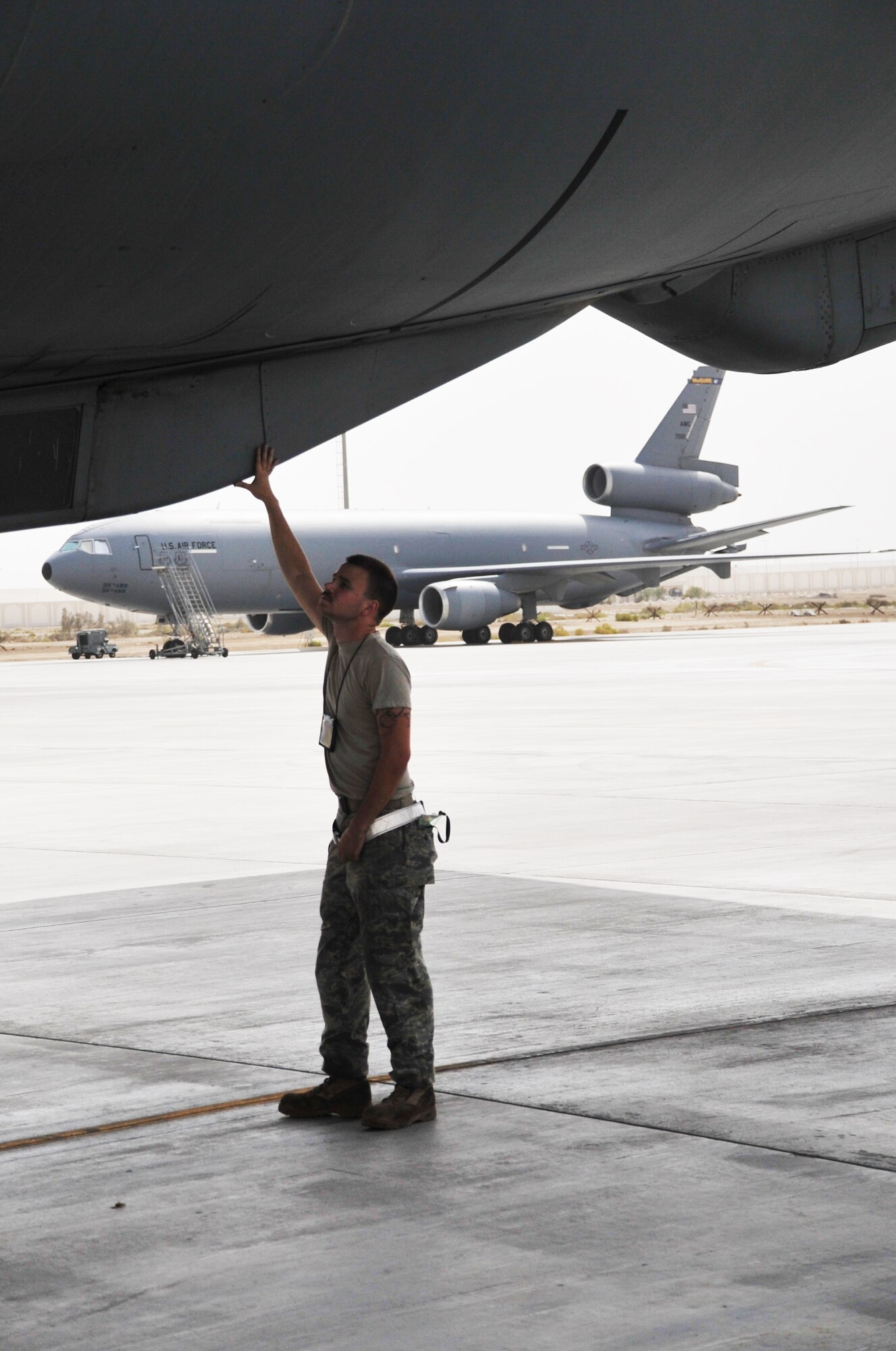 Airman 1st Class Brian Welch, KC-10 Extender crew chief with the 380th Expeditionary Aircraft Maintenance Squadron Extender aircraft maintenance unit, works on a KC-10 during operations for the 380th Air Expeditionary Wing at a non-disclosed base in Southwest Asia on April 24, 2010. Airman Welch is deployed from the 660th Aircraft Maintenance Squadron at Travis Air Force Base, Calif. (U.S. Air Force Photo/Master Sgt. Scott T. Sturkol/Released)