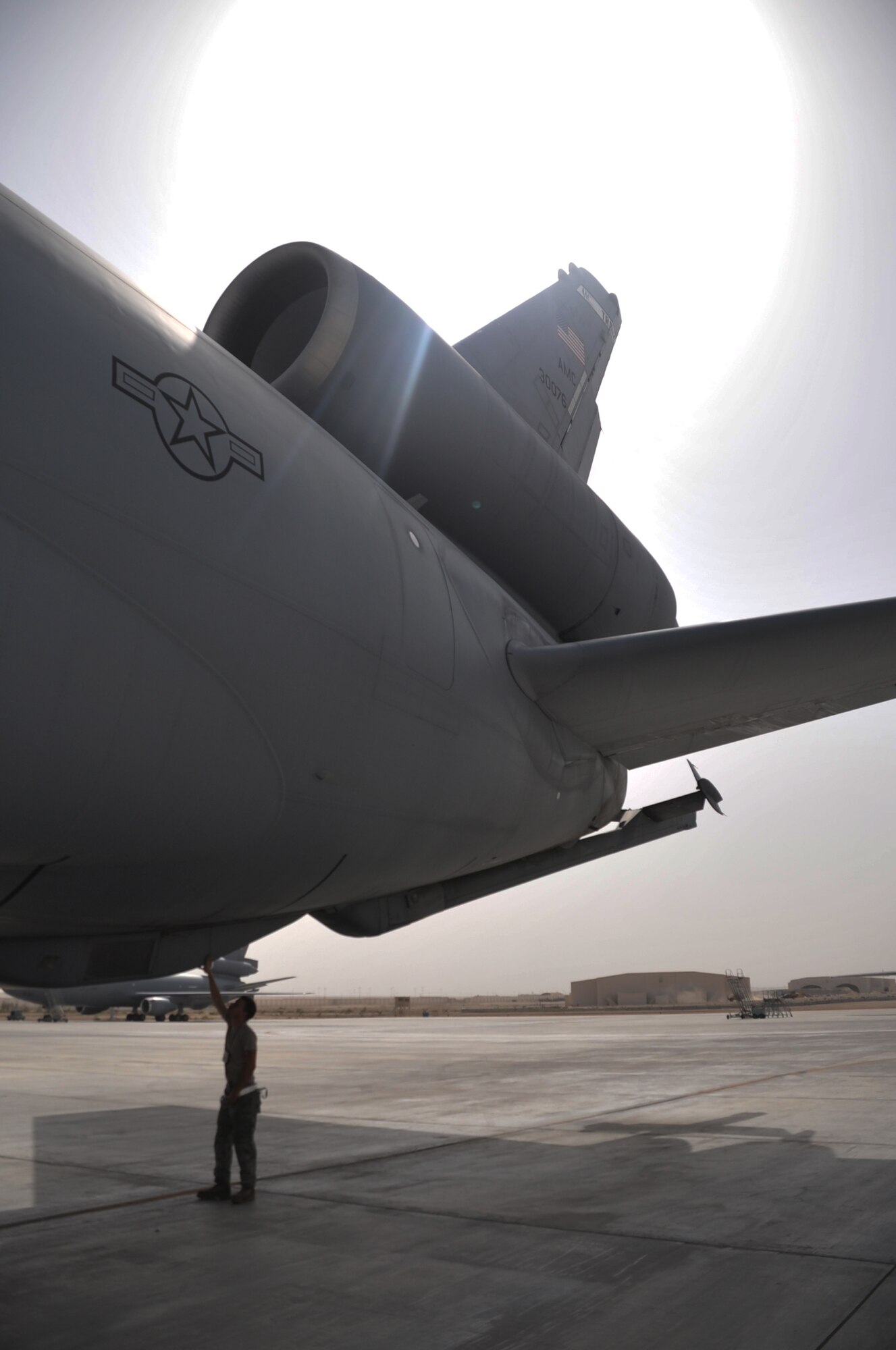 Airman 1st Class Brian Welch, KC-10 Extender crew chief with the 380th Expeditionary Aircraft Maintenance Squadron Extender aircraft maintenance unit, works on a KC-10 during operations for the 380th Air Expeditionary Wing at a non-disclosed base in Southwest Asia on April 24, 2010. Airman Welch is deployed from the 660th Aircraft Maintenance Squadron at Travis Air Force Base, Calif. (U.S. Air Force Photo/Master Sgt. Scott T. Sturkol/Released)