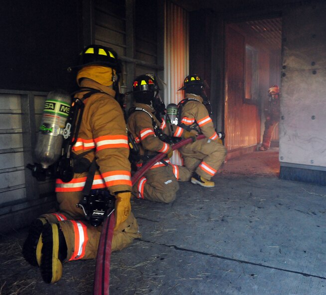 100427-F-6838W-010
SHAW AIR FORCE BASE, S.C. -- Staff Sgt. Jarius Ballard, Airman 1st Class Aaron Hanson and Airman 1st Class Justin Ray battle a fire during a structural fire training exercise April 27, 2010. The 20th Civil Engineer Squadron plans exercises like this throughout the year to provide hands on experience and training. (U.S. Air Force photo/Airman 1st Class Neil D. Warner)