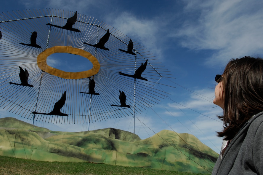 THE ENCHANTED HIGHWAY, N.D. – Alaina Dow, wife of Tech. Sgt. Thomas Dow, 5th Bomb Wing public affairs craftsman, looks up at the sculpture titled “Geese in Flight” at the start of the Enchanted Highway here April 23. The highway stretches north from Regent, N.D., to exit 72 on Interstate 94. “Geese in Flight” is one of seven sculptures by artist Gary Greff, and is in the Guinness Book of World Records for being the largest scrap metal sculpture. (U.S. Air Force photo by Tech. Sgt. Thomas Dow)