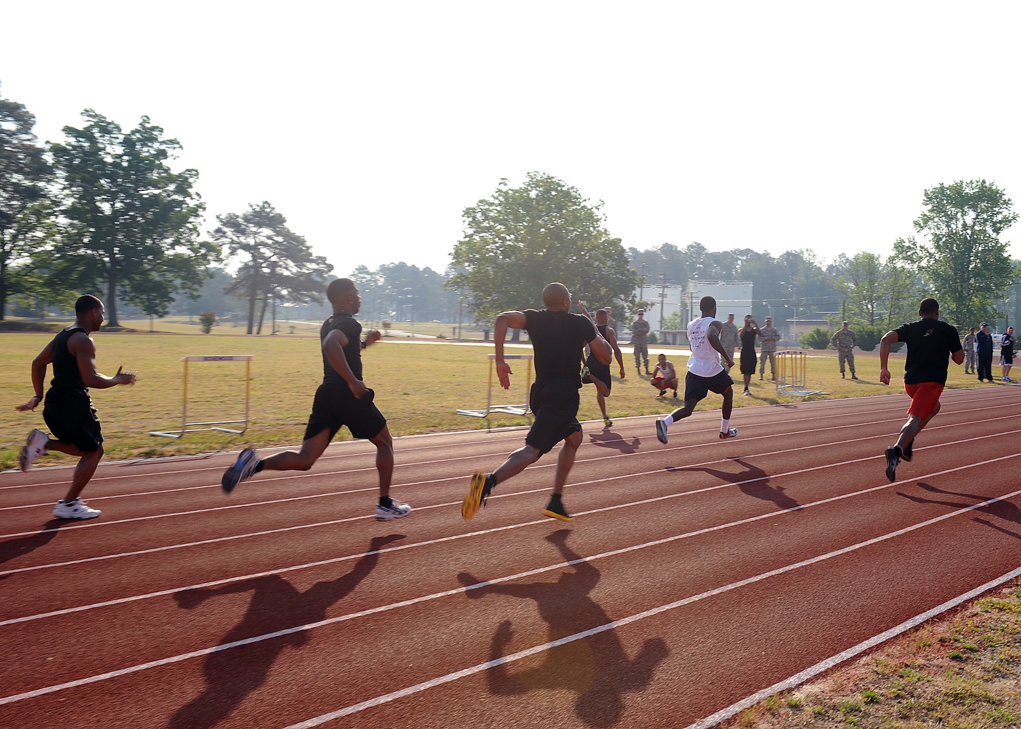 SEYMOUR JOHNSON AIR FORCE BASE, N.C. -- Six 100-meter dash runners sprint to the finish line during the 4th Security Forces Squadron spring track meet here, April 23, 2010. Twenty-seven men participated in the 100-meter dash. The 4th Force Support Squadron received a trophy for the highest total score. (U.S. Air Force photo/Senior Airman Whitney Lambert)