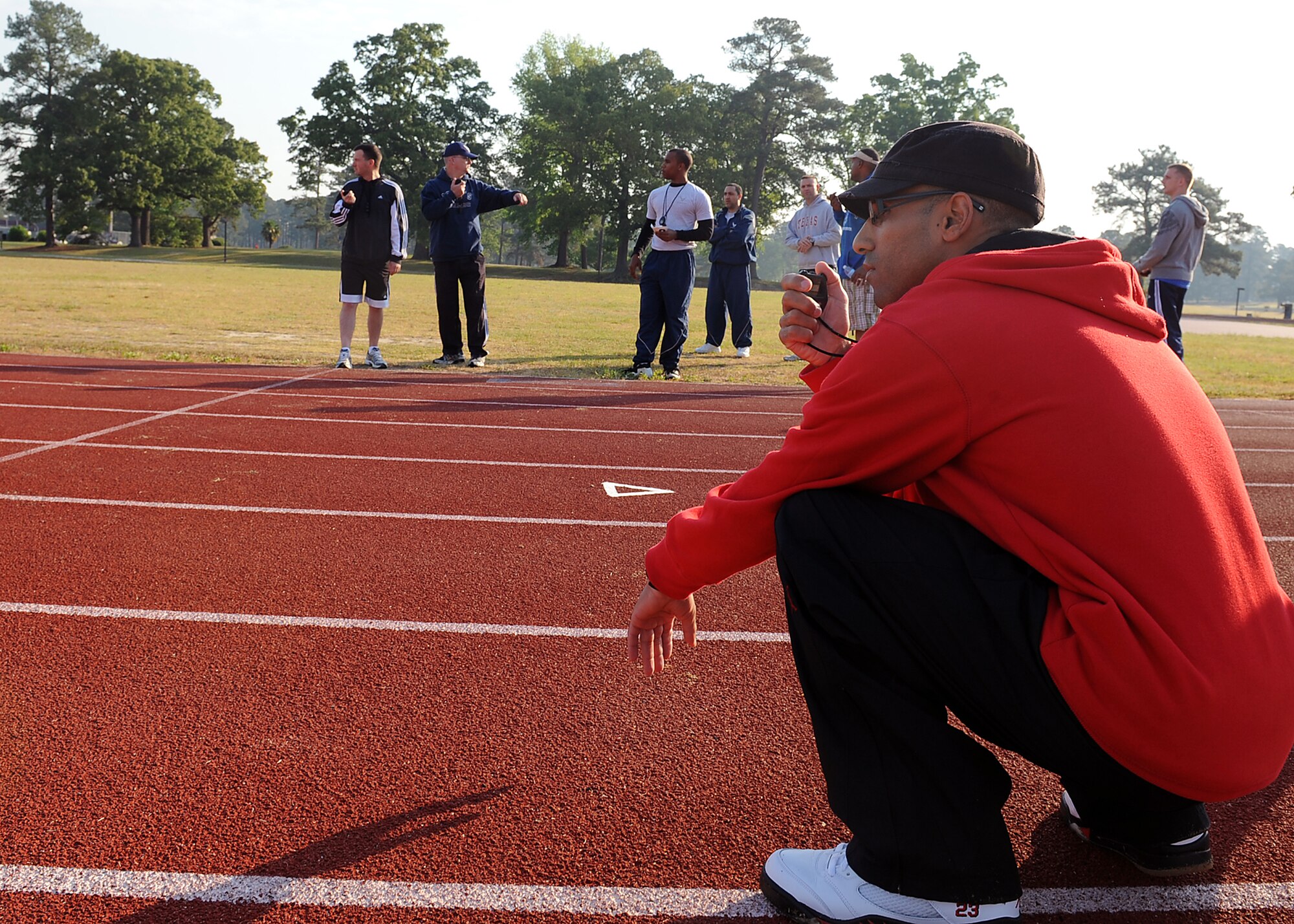 SEYMOUR JOHNSON AIR FORCE BASE, N.C. -- Tech. Sgt. Samuel Figueroa, Jr. starts a timer at the beginning of a race here, April 23, 2010. Sergeant Figueroa, a native of Ceiba, Puerto Rico, volunteered to time runners during the spring track meet sponsored by the 4th Security Forces Squadron. (U.S. Air Force photo/Senior Airman Whitney Lambert)
