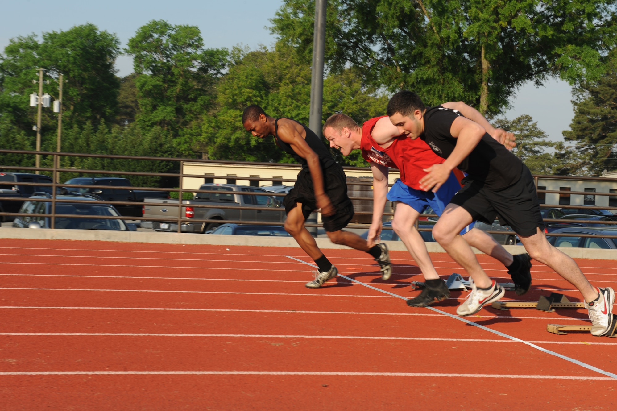 SEYMOUR JOHNSON AIR FORCE BASE, N.C. -- Hurdlers push off the blocks to begin the 100-meter race here, April 23, 2010. The 4th Security Forces Squadron hosted a spring track meet to raise money for fuel cards for the Airmen Against Drunk Driving program. (U.S. Air Force photo/Senior Airman Whitney Lambert)