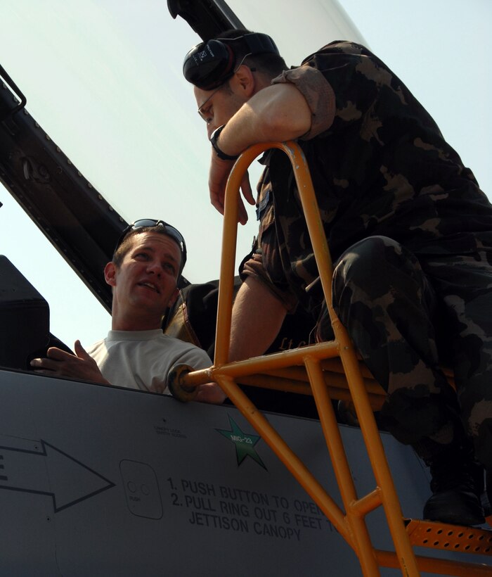 KECSKEMET, Hungary -- Staff Sgt. Steve Smith, a 178th Fighter Wing crew chief, shows a Hungarian Air Force aircraft maintainer the cockpit of a F-16 Fighting Falcon and explains safety procedures during the Load Diffuser Exercise 2010 in Kecskemet, Hungary April 27. The exercise aims to sharpen the combat capabilities of the participating forces by conducting a 10 to 15 day flying program.