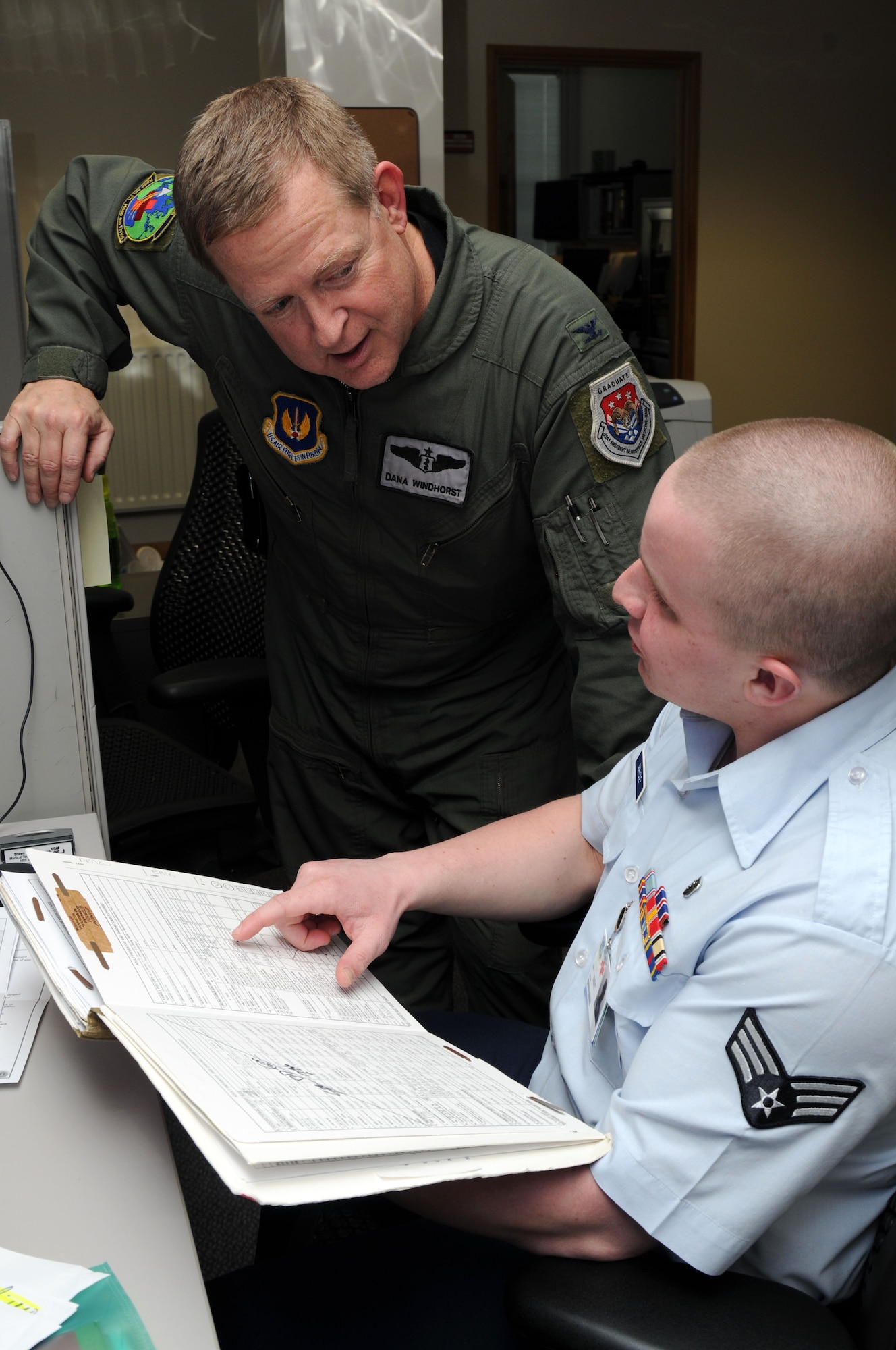 Col. Dana Windhorst, 48th Medical Group Chief of Aerospace Medicine, reviews patient’s preventive health assessment files with Senior Airman Shawn Mahoney, 48th Medical Group medical technician, at RAF Lakenheath on April 19. PHA files help to ensure airman are staying medically ready to deploy. (U.S. Air Force photo by Airman 1st Class Lausanne Morgan)

