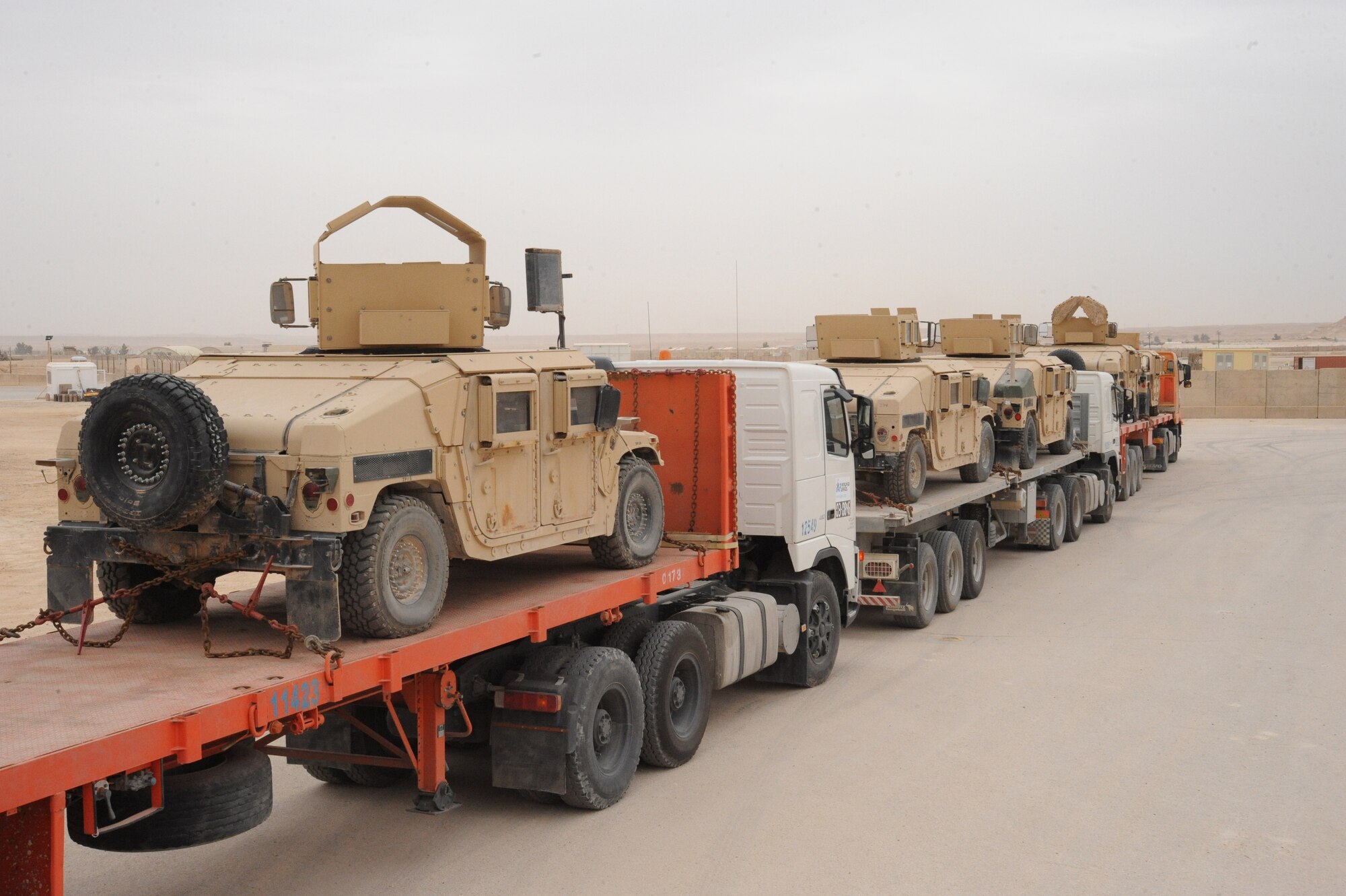 Several eighteen wheelers loaded with humvee wait to leave the Redistribution Property Assistance Teams yard whose final destination is Arifjan, Kuwait, as part of the drawdown, Al Asad Air Base, Iraq, April 17, 2010. The mission of the RPAT is to meet the presidential intent to facilitate the expedient turn-in of all excess Class VII Theater Provided Equipment, improve property accountability of retrograding equipment from Iraq and enable asset visibility of the received equipment during transit to Source of Repair or Operation Enduring Freedom. (U.S. Air Force photo/Master Sgt. Trish Bunting/Released)