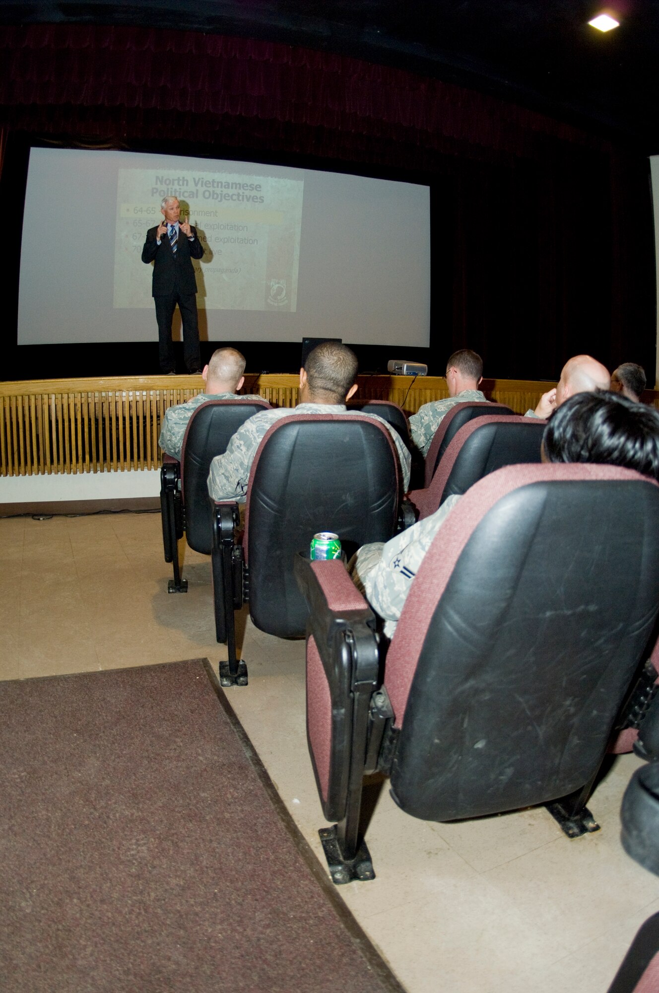 MINOT AIR FORCE BASE, N.D. -- Retired Lt. Col. Barry Bridger talks with Minot Airmen about his experiences as a six-year prisoner of war during the Vietnam War at the base theater here April 23. On Jan. 23, 1967, Colonel Bridger was shot down over Son Tay, North Vietnam, by a surface-to-air missile and subsequently captured and tortured for six years. He escaped to complete a fruitful career and retire after 22 years of service. He now travels the nation teaching today’s Airmen about the monumentous sacrifice POWs and servicemembers missing in action make for the freedom of all Americans. (U.S. Air Force photo by Senior Airman Benjamin Stratton)