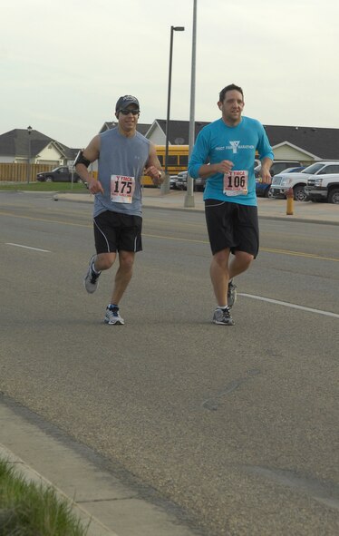 MINOT, N.D. -- Capt. Ruben Velez, 5th Operations Group intelligence officer, and Senior Airman James Eusepi, 5th Civil Engineer Squadron electrician, participate in the Minot Family YMCA Marathon April 24 here as training for the upcoming Air Force Marathon at Wright-Patterson AFB, Ohio. (U.S. Air Force photo by Senior Airman Benjamin Stratton)