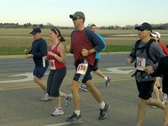 MINOT, N.D. -- Capt. Kera Rolsen, 23rd Bomb Squadron executive officer, and her husband Capt. John Rolsen, 69th Bomb Squadron electronic warfare officer, participate in the Minot Family YMCA Marathon April 24 here as training for the upcoming Air Force Marathon at Wright-Patterson AFB, Ohio. (U.S. Air Force photo by Senior Airman Benjamin Stratton)