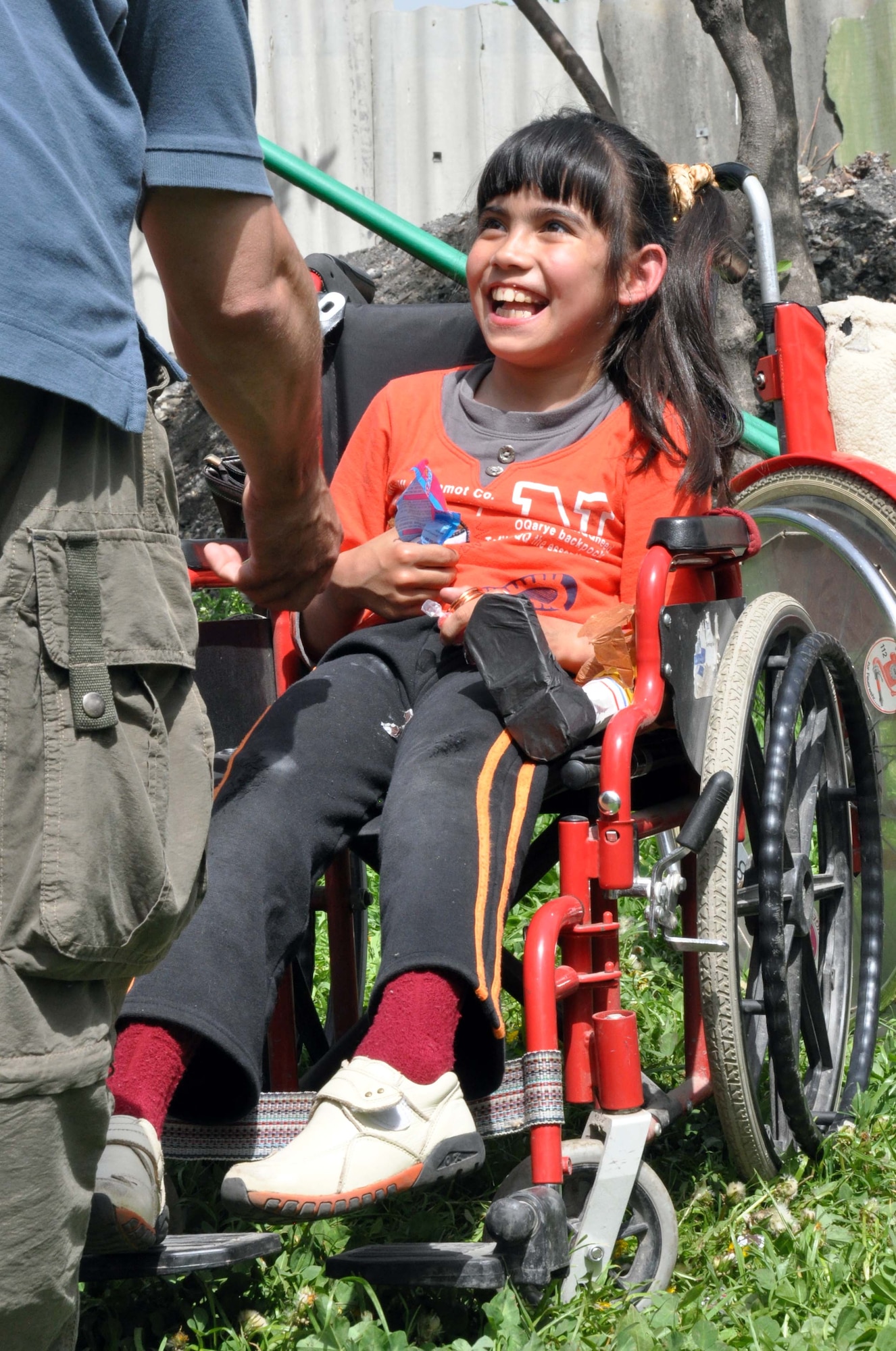 A girl from the Nadjeshda Children's Center is happy to receive treats from Airmen from the Transit Center at Manas, Kyrgyzstan, April 27, 2010. Nadjeshda is home for 60 children and teenagers who are disabled in different ways. With the help of adults, children there are able to learn to sign, draw, study, work and have fun using various methods of therapy. U.S. Airmen have supported Nadjeshda for the last six years, helping rebuild and repair the facility and spending time with the children. (U.S. Air Force photo/Staff Sgt. Carolyn Viss)