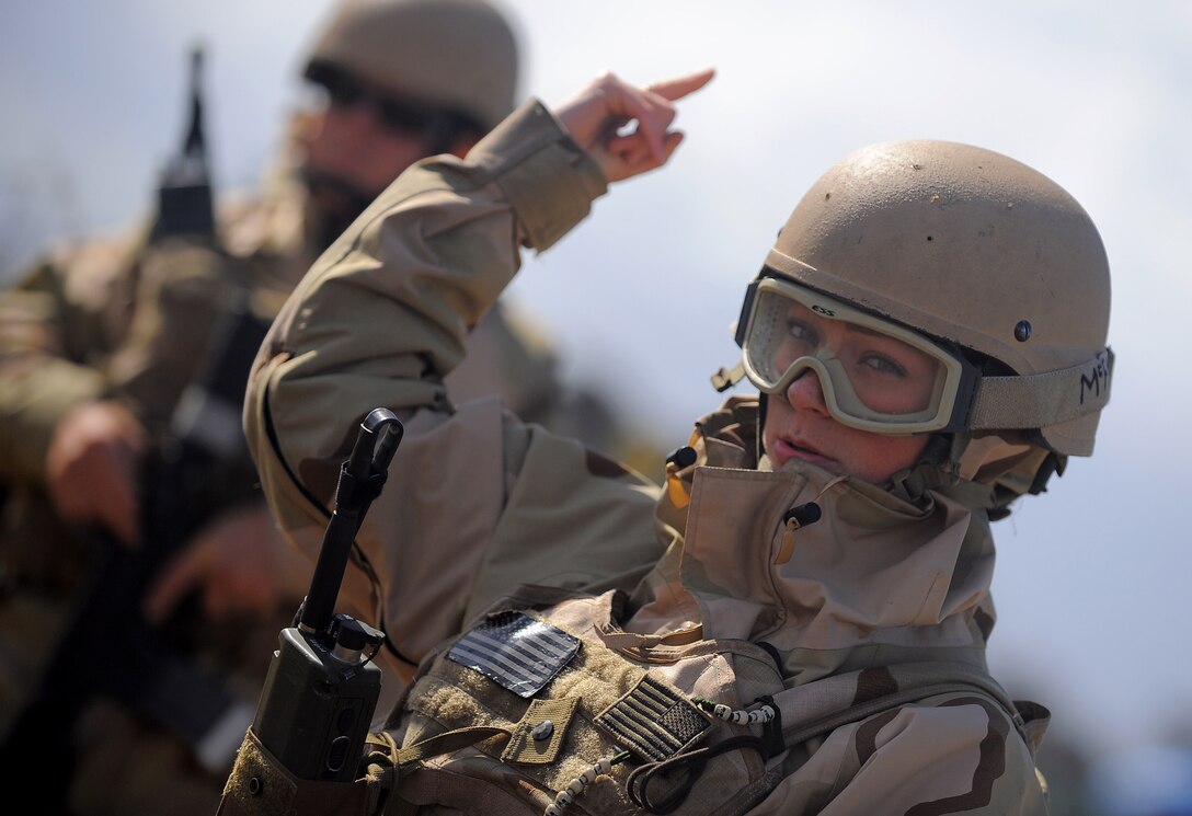 U.S. Navy Petty Officer 3rd Class Alyson Mills signals to security watch standers on a simulated forward operating base during a Navy Expeditionary Combat Command exercise in San Diego, April 21, 2010.