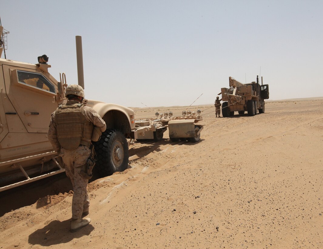 Marines with Combat Logistics Battalion 5, 1st Marine Logistics Group (Forward), uses a wrecker to pull a stuck vehicle out of the sandy desert in Helmand Province, Afghanistan, during a recovery mission April 28. Soft sand can cause vehicles to get stuck while driving through the desert. Wrecker teams help save a great amount of money and resources for the Marine Corps by retrieving damaged or broken-down vehicles and transporting them back to base camp for repair.