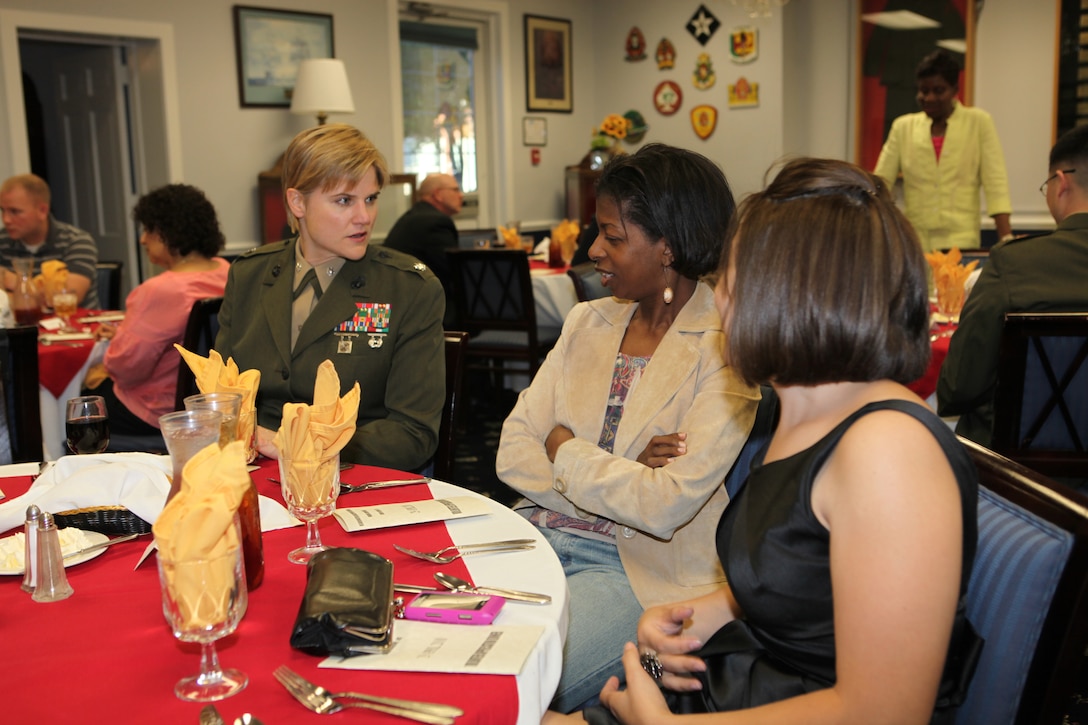 Lt. Col. Susan B. Seaman (left), battalion commander of Headquarters and Support Battalion, Marine Corps Base Camp Lejeune, talks with family readiness volunteers Sharon Walker (center) and Sharon Ayala (right) during the Volunteer Appreciation Dinner at the Paradise Point Officers’ Club aboard MCB Camp Lejeune, April 29.  Seaman thanked these volunteers who have helped support military families by giving them certificates of appreciation and gift bags.