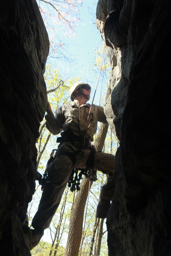 Lance Cpl. John Rasoilo, a rifleman with Company I, Battalion Landing Team 3/8, 26th Marine Expeditionary Unit, looks for a hand-hold while practicing the top rope climbing technique during a class at the Assault Climbers Course at Cooper’s Rock in Kingwood, W.Va., April 27, 2010.  The Marines climbed the rock face using protective gear, known as 'friends.' For additional safety while practicing friend placement, the Marines used a safety line. The Assault Climbers Course is one of several Special Operations Training Group, II Marine Expeditionary Force, events as part of 26th MEU's preparation for deployment this fall. (Official USMC photo by Staff Sgt. Danielle M. Bacon) (Released)