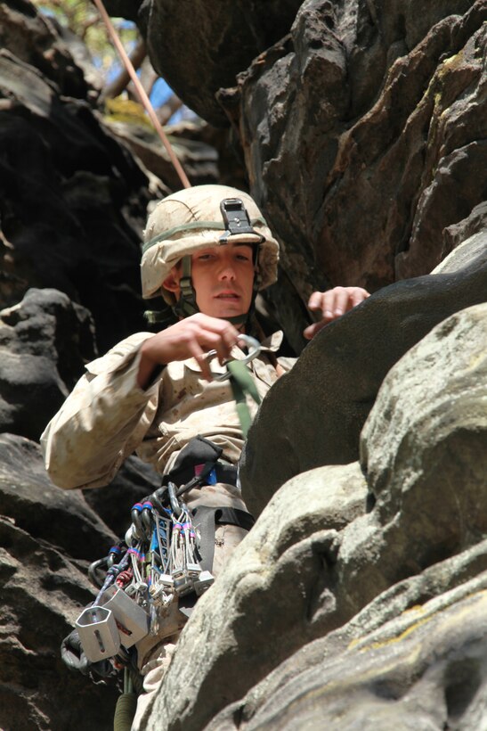 Lance Cpl. John Rasoilo, a rifleman with  Company I, Battalion Landing Team 3/8, 26th Marine Expeditionary Unit, looks to place protective gear in the rock while practicing the top rope climbing technique during a class at the Assault Climbers Course at Cooper’s Rock in Kingwood, W.Va., April 27, 2010.  The Marines climbed the rock face using protective gear, known as 'friends.' For additional safety while practicing friend placement, the Marines used a safety line. The Assault Climbers Course is one of several Special Operations Training Group, II Marine Expeditionary Force, events as part of 26th MEU's preparation for deployment this fall.