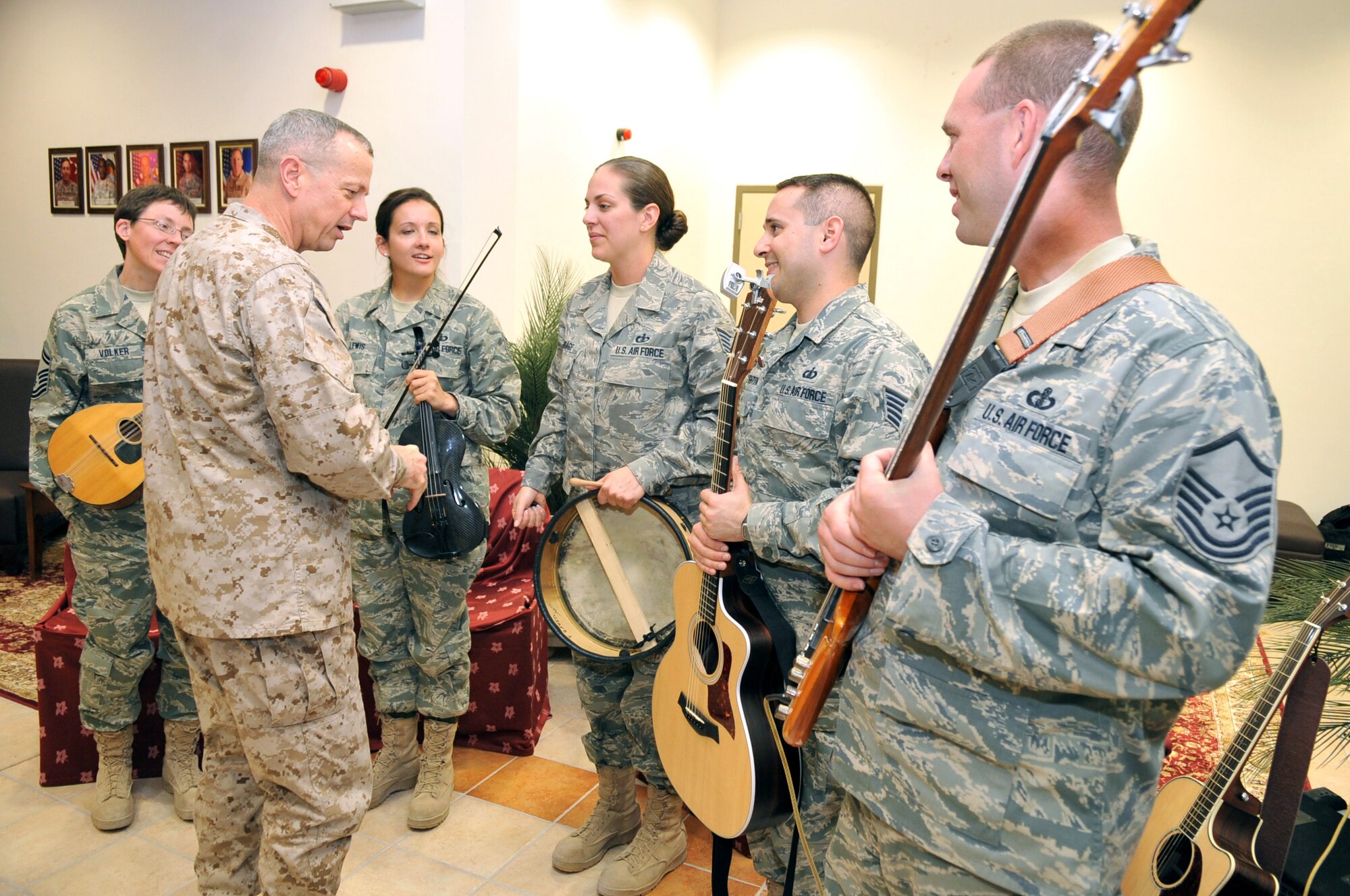 Members of Celtic Aire meet with Lieutenant General John R. Allen, Deputy Commander of U.S. Central Command, after a performance.  Members of Celtic Aire include (left to right) Senior Master Sgt. Deb Volker, Technical Sgts. Emily Lewis, Julia Brundage and Joe Haughton, and Master Sgt. Eric Sullivan. The deployment was part of the mission of the U.S. Air Forces Central Expeditionary Band. Based in Southwest Asia, the Band is comprised of deployed Airmen from Active Duty, Reserve and Air National Guard bands. The Band rotates several ensembles through the region that perform a wide variety of musical styles to appeal to audiences of all ages and backgrounds.