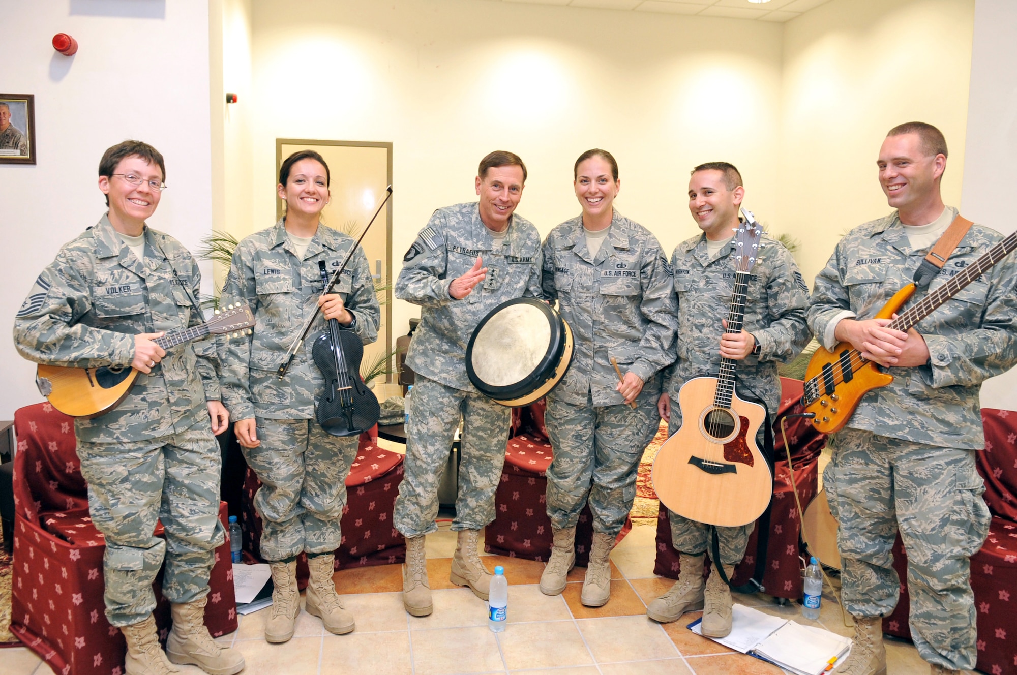 General David Petraeus, Commander of the U.S. Central Command, gets a music lesson from the members of Celtic Aire.  Members of Celtic Aire include (left to right) Senior Master Sgt. Deb Volker, Technical Sgts. Emily Lewis, Julia Brundage and Joe Haughton, and Master Sgt. Eric Sullivan.  The ensemble was deployed to Central and Southwest Asia to perform for joint forces, as well as in local communities, hospitals and schools. 