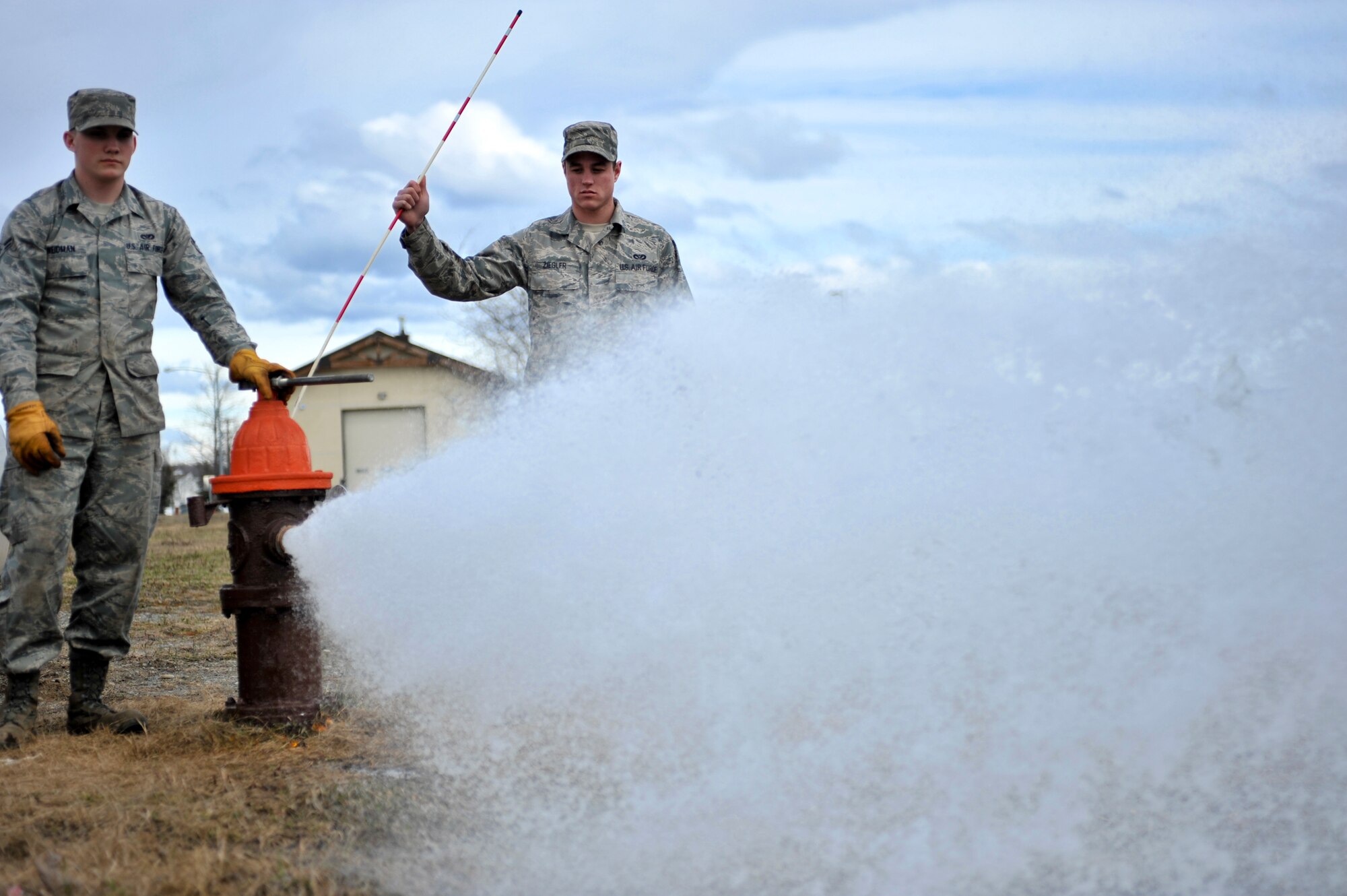 ELMENDORF AIR FORCE BASE, Alaska – Airman 1st Class Joseph Weidman and Airman Steven Ziegler from the 3rd Civil Engineer Squadron Water and Fuel System Maintenance, standby as they release water from one of Elmendorf’s fire hydrants April 29. The fluoride levels in the water have been elevated at Elmendorf and Fort Richardson. By releasing some of the water on Elmendorf at various hydrants it decreases the fluoride level. (Air Force photo by Airman 1st Class Christopher Gross)
