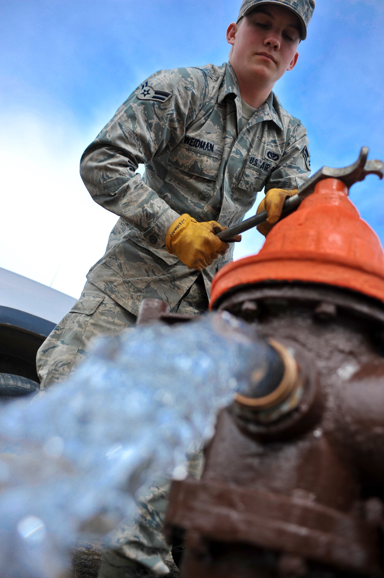 ELMENDORF AIR FORCE BASE, Alaska – Airman 1st Class Joseph Weidman, 3rd Civil Engineer Squadron Water and Fuel System Maintenance, releases water from one of Elmendorf’s fire hydrants April 29. The fluoride levels in the water have been elevated at Elmendorf and Fort Richardson. By releasing some of the water on Elmendorf at various hydrants it decreases the fluoride level. (Air Force photo by Airman 1st Class Christopher Gross)