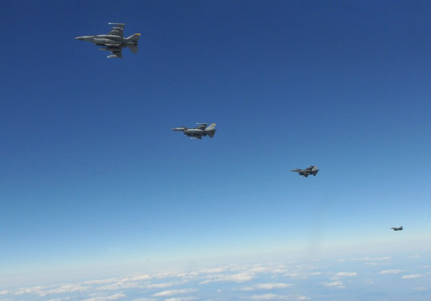 Four F-16 Fighting Falcons pilots with the 8th Fighter Wing's 80th Fighter Squadron, Kunsan Air Base, Republic of Korea, fly back into the simulated war after refueling from a KC-135 Stratotanker from McConnell Air Force Base, Kansas, during Red Flag-Alaska April 27. Red Flag-Alaska is a 10-day air combat training exercise that provides multi-service, multi-platform coordinated, combat operations in a simulated combat environment. (U.S. Air Force photo/Capt. Shannon Collins)