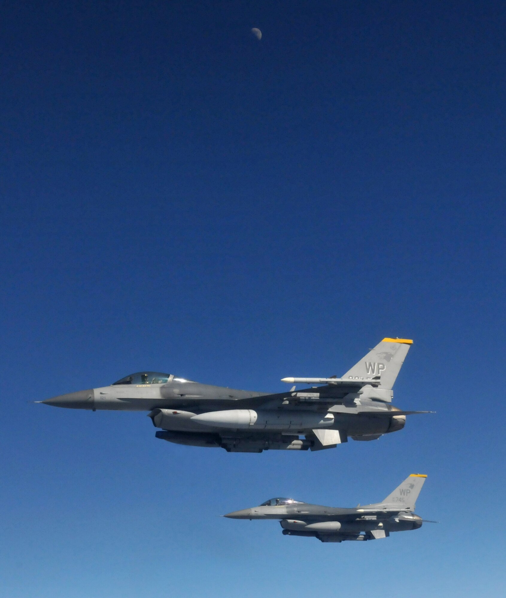 Two F-16 Fighting Falcons pilots from the 8th Fighter Wing's 80th Fighter Squadron, Kunsan Air Base, Republic of Korea, move into position and wait for the last two members of their four-ship after receiving fuel from the boom of a KC-135 Stratotanker from McConnell Air Force Base, Kansas, during Red Flag-Alaska April 21. Red Flag-Alaska is a 10-day field training exercise that provides joint offensive counter-air, interdiction, close air support and large force employment training in a simulated combat environment. (U.S. Air Force photo/Capt. Shannon Collins)