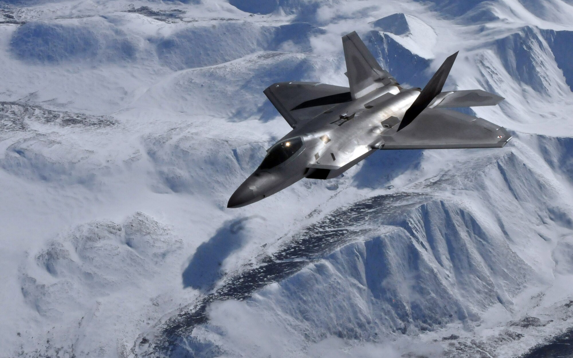 An F-22 Raptor pilot from the 525th Fighter Squadron, Elmendorf Air Force Base, Alaska, moves into position and waits for his wingman after receiving fuel from the boom of a KC-135 Stratotanker from McConnell Air Force Base, Kansas, during Red Flag-Alaska April 21. Red Flag-Alaska is a 10-day field training exercise that provides joint offensive counter-air, interdiction, close air support and large force employment training in a simulated combat environment. (U.S. Air Force photo/Capt. Shannon Collins)