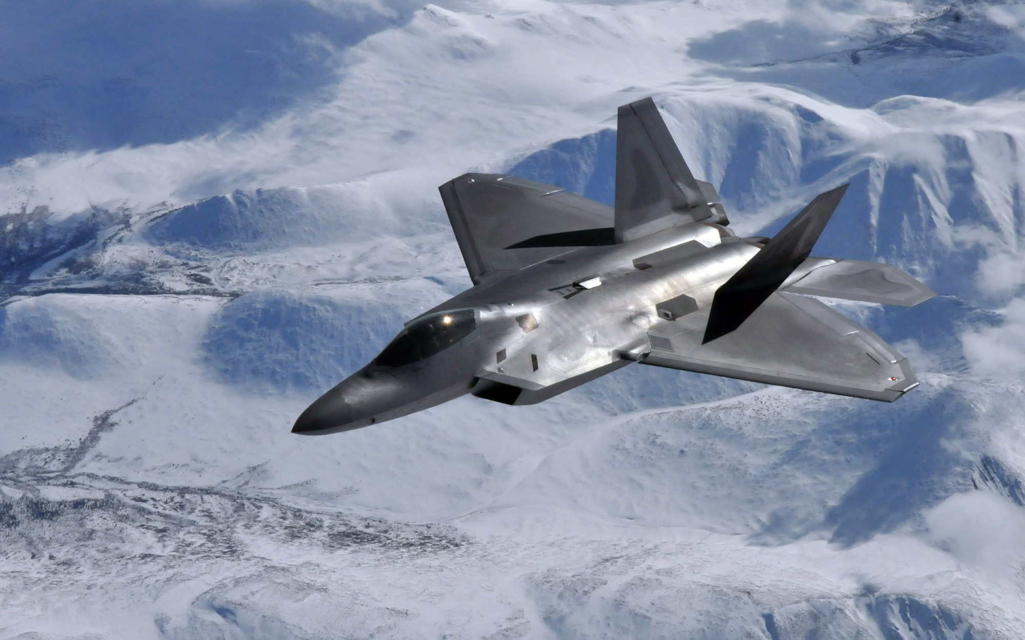 An F-22 Raptor pilot from the 525th Fighter Squadron, Elmendorf Air Force Base, Alaska, moves into position and waits for his wingman after receiving fuel from the boom of a KC-135 Stratotanker from McConnell Air Force Base, Kansas, during Red Flag-Alaska April 21. Red Flag-Alaska is a 10-day field training exercise that provides joint offensive counter-air, interdiction, close air support and large force employment training in a simulated combat environment. (U.S. Air Force photo/Capt. Shannon Collins)