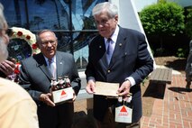 Retired Colonel Roland Guildry(right), former 8th Special Operations Squadron commander, speaks with former Airmen of Operation Eagle Claw, after receiving two cases of beer from a British exchange pilot April 29.  One legacy from the operation that has lived on today is the motto of the 8th SOS, “With the guts to try.” This phrase came after two British Airmen quietly delivered two cases of beer with the words “To you all, from us all, for having the guts to try” scribbled across the cardboard lid of one of the cases.  DoD photo by U.S. Air Force Senior Airman Matthew Loken)