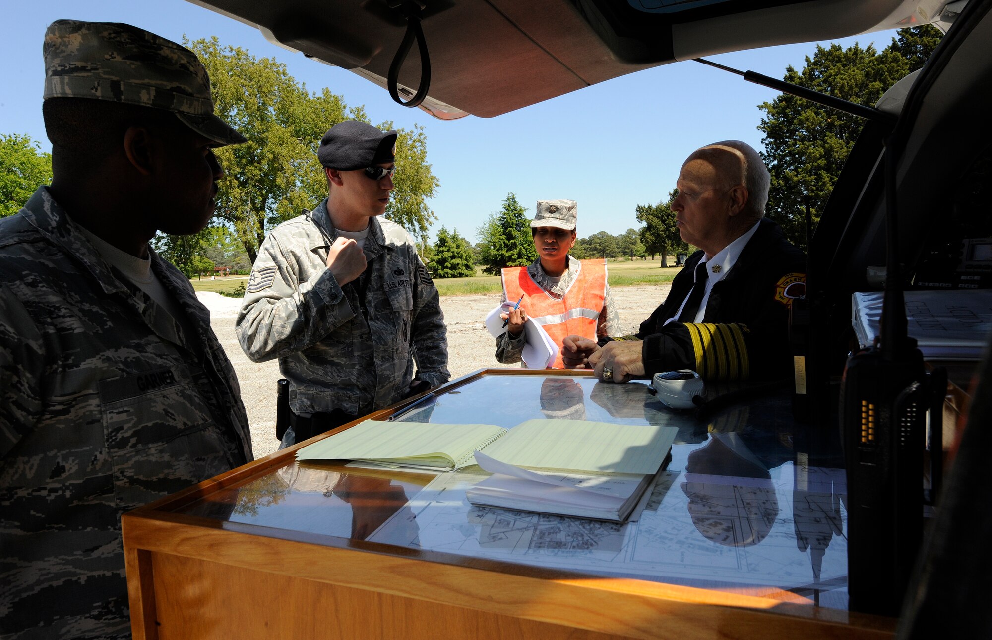 LANGLEY AIR FORCE BASE, Va. – Members of the mobile command post discuss actions to take during a Major Accident Response Exercise April 29. This is the first time Langley’s held a MARE with a tornado scenario, testing first responders and base personnel’s preparedness and ability to respond to a natural disaster. (U.S. Air Force photo/Senior Airman Dana Hill)