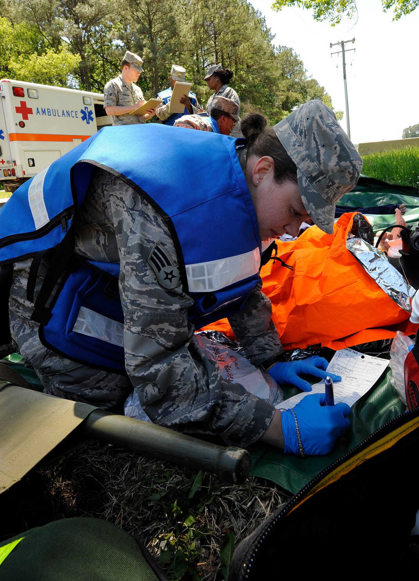 LANGLEY AIR FORCE BASE, Va. -- Senior Airman Felicita Torres-Perkins, 633d Medical Group aerospace medical technician, writes down victim information during a Major Accident Response Exercise April 29. This is the first time Langley’s held a MARE with a tornado scenario, testing first responders and base personnel’s preparedness and ability to respond to a natural disaster. (U.S. Air Force photo/Senior Airman Dana Hill)