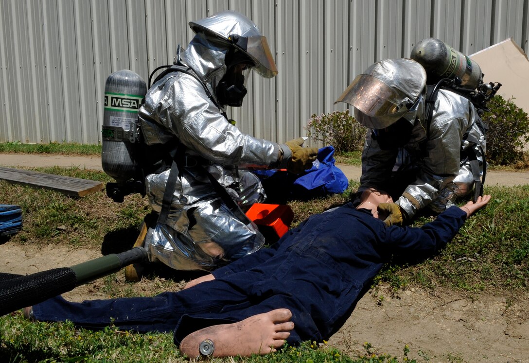 LANGLEY AIR FORCE BASE, Va. -- Firefighter’s with the 633d Civil Engineer Squadron, examine causalities during a Major Accident Response Exercise April 29. This is the first time Langley’s held a MARE with a tornado scenario, testing first responders and base personnel’s preparedness and ability to respond to a natural disaster. (U.S. Air Force photo/Senior Airman Dana Hill)