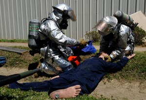 LANGLEY AIR FORCE BASE, Va. -- Firefighter’s with the 633d Civil Engineer Squadron, examine causalities during a Major Accident Response Exercise April 29. This is the first time Langley’s held a MARE with a tornado scenario, testing first responders and base personnel’s preparedness and ability to respond to a natural disaster. (U.S. Air Force photo/Senior Airman Dana Hill)