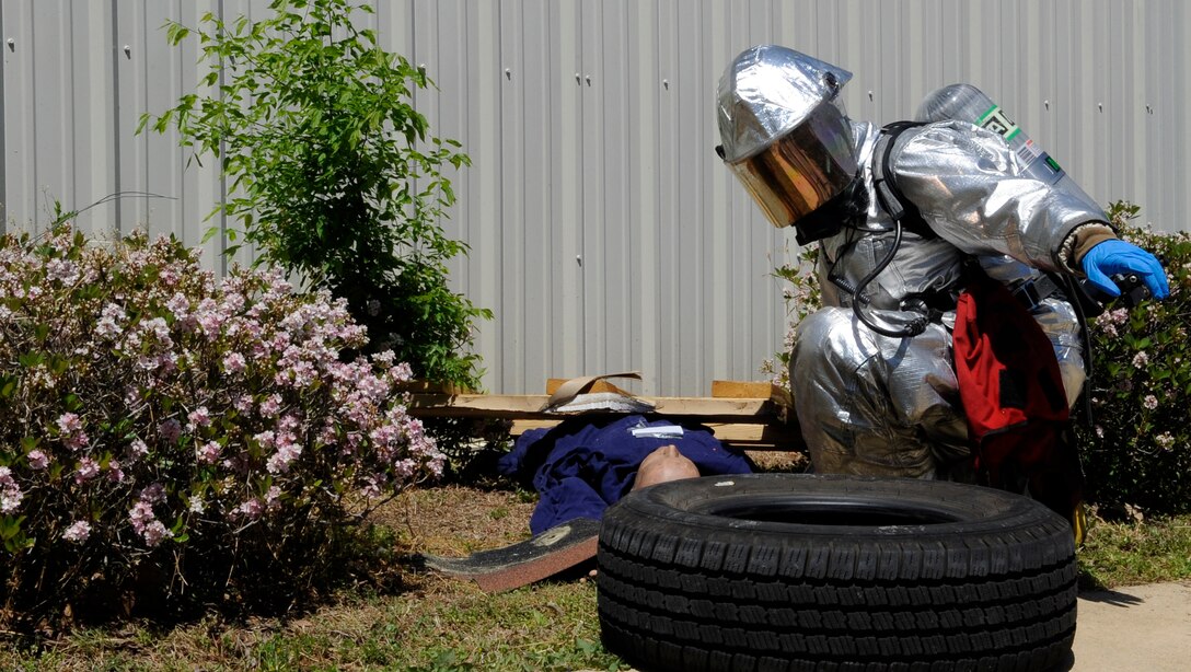 LANGLEY AIR FORCE BASE, Va. -- A Firefighter with the 633d Civil Engineer Squadron, examines a causality during a Major Accident Response Exercise April 29. This is the first time Langley’s held a MARE with a tornado scenario, testing first responders and base personnel’s preparedness and ability to respond to a natural disaster. (U.S. Air Force photo/Senior Airman Dana Hill)