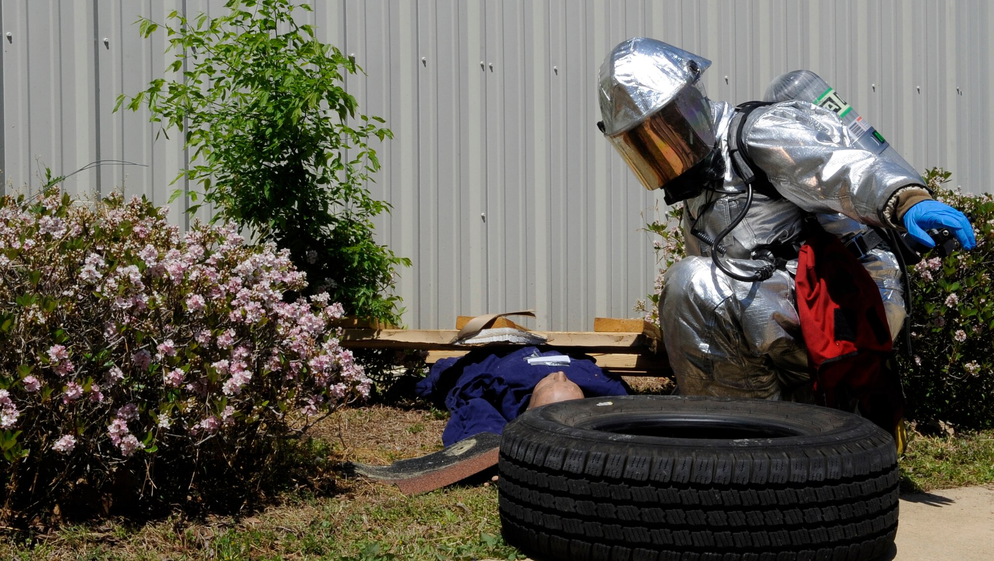 LANGLEY AIR FORCE BASE, Va. -- A Firefighter with the 633d Civil Engineer Squadron, examines a causality during a Major Accident Response Exercise April 29. This is the first time Langley’s held a MARE with a tornado scenario, testing first responders and base personnel’s preparedness and ability to respond to a natural disaster. (U.S. Air Force photo/Senior Airman Dana Hill)