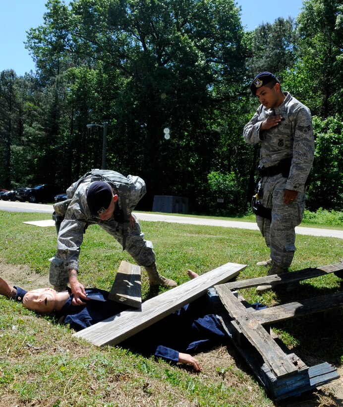 LANGLEY AIR FORCE BASE, Va. -- Senior Airman Jeremy Mcmasters, 633d Security Forces Squadron patrolman, evaluates a casualty while SrA Michael Ornelaz, 633d SFS patrolman, radios the casualties’ condition into dispatch during a Major Accident Response Exercise April 29. This is the first time Langley’s held a MARE with a tornado scenario, testing first responders and base personnel’s preparedness and ability to respond to a natural disaster. (U.S. Air Force photo/Senior Airman Dana Hill)