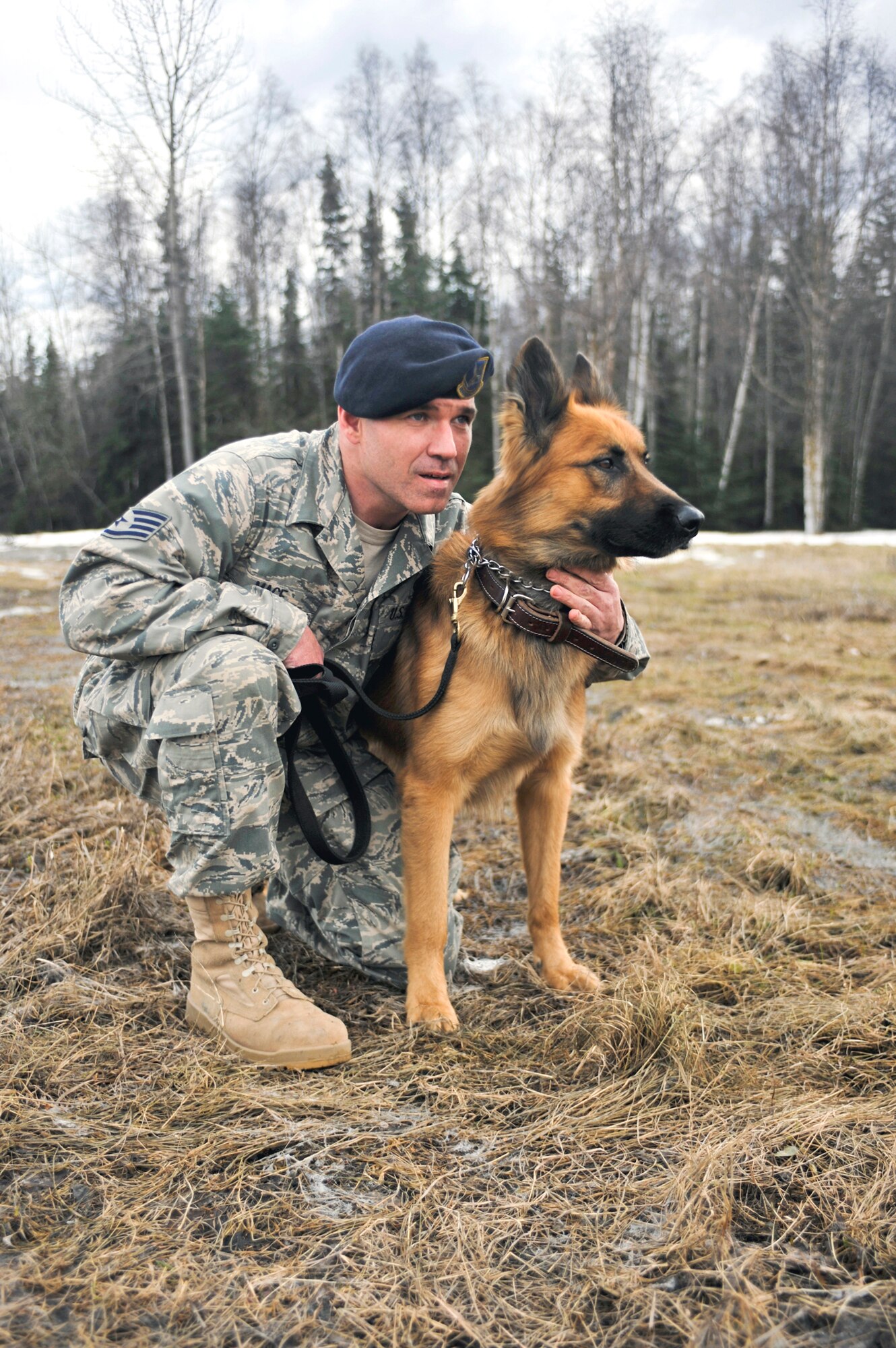 ELMENDORF AIR FORCE BASE, Alaska – Staff Sgt. Terry Mace, 3rd Security Forces Squadron Military Working Dog handler, relaxes with his dog Palli April 23. Sergeant Mace and Palli recently returned from Camp Taji, Iraq, where they uncovered a large weapons cache, which consisted of two AK-47s, 15 magazines of 7.62 ammunition and a box full of 200 loose rounds of ammunition. (Air Force photo by Airman 1st Class Christopher Gross)