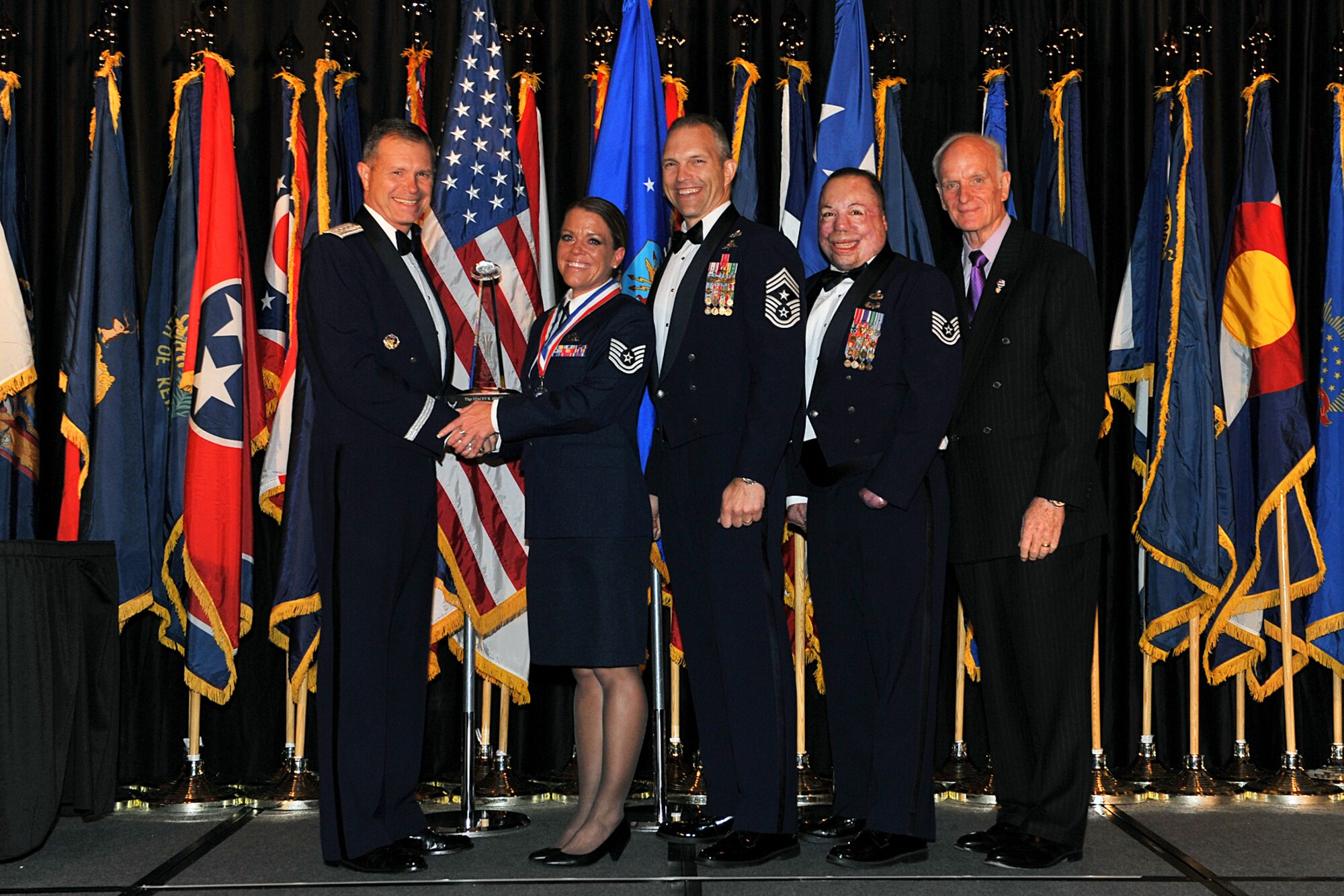 LA VISTA, Neb. -- Tech. Sgt. Stacey Hines receives the Outstanding Honor Guard Program Manager of the Year Award from Gen. William Fraser, Chief Master Sgt. Martin Klukas, Tech. Sgt. Israel Del Toro and Arthur Myers during Air Combat Command’s 2010 Outstanding Airmen of the Year banquet here April 21, 2010. Sergeant Hines, a Zanesville, Ohio, native, is the 4th Fighter Wing Honor Guard NCOIC. General Fraser is the ACC commander and Chief Klukas is the ACC command chief. Sergeant Del Toro and Mr. Myers were the keynote speakers at the banquet. (U.S. Air Force photo/Charles Haymond)