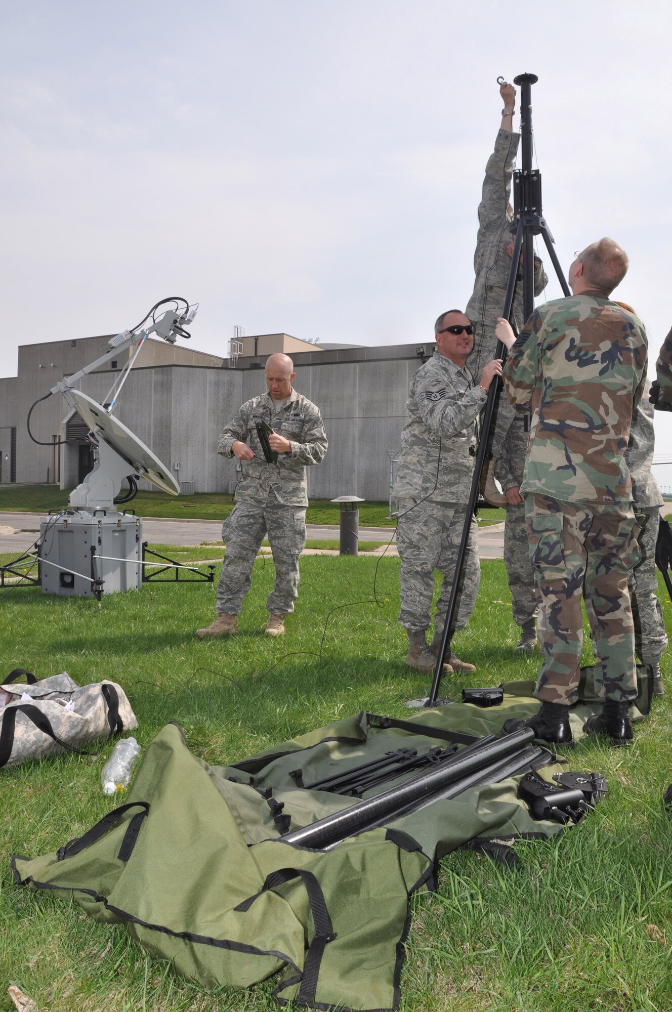 Members of the 934th  Communications Flight practice setting up the emergency communications antennae and sattilite dish during initial setup up here. The 934th Communications Flight has received a new mission coordinating emergency communication during man made or natural disaster. (Air Force phot/Tech. Sgt. Bob Sommer)