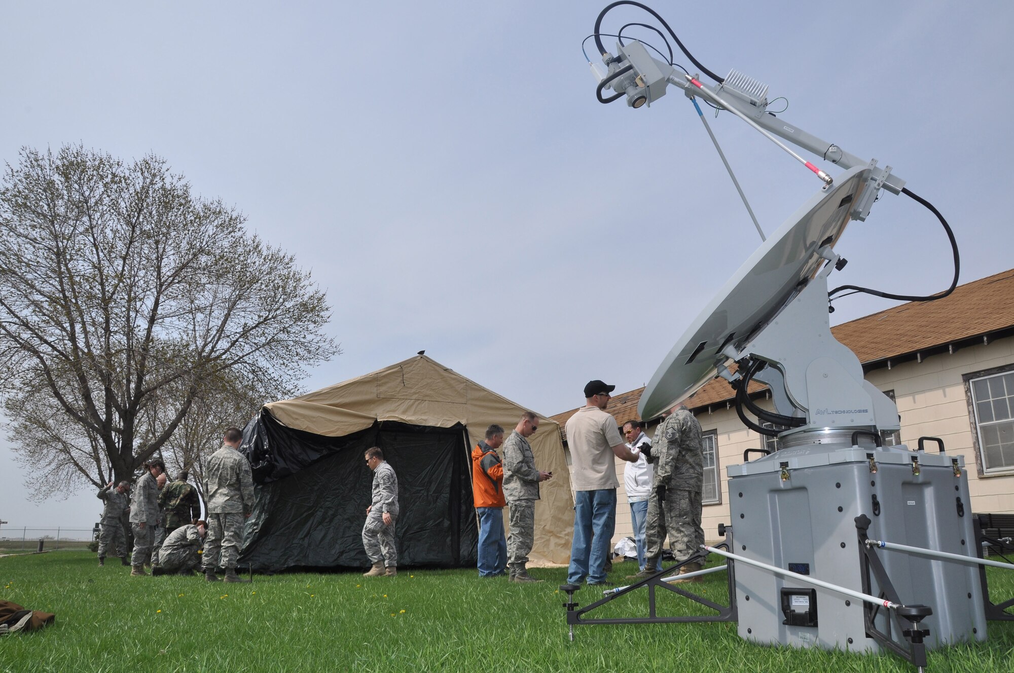 Members of the 934th  Communications Flight practice setting up the emergency communications tent and sattilite dish during initial setup up here. The 934th Communications Flight has received a new mission coordinating emergency communication during man made or natural disaster. (Air Force phot/Tech. Sgt. Bob Sommer)