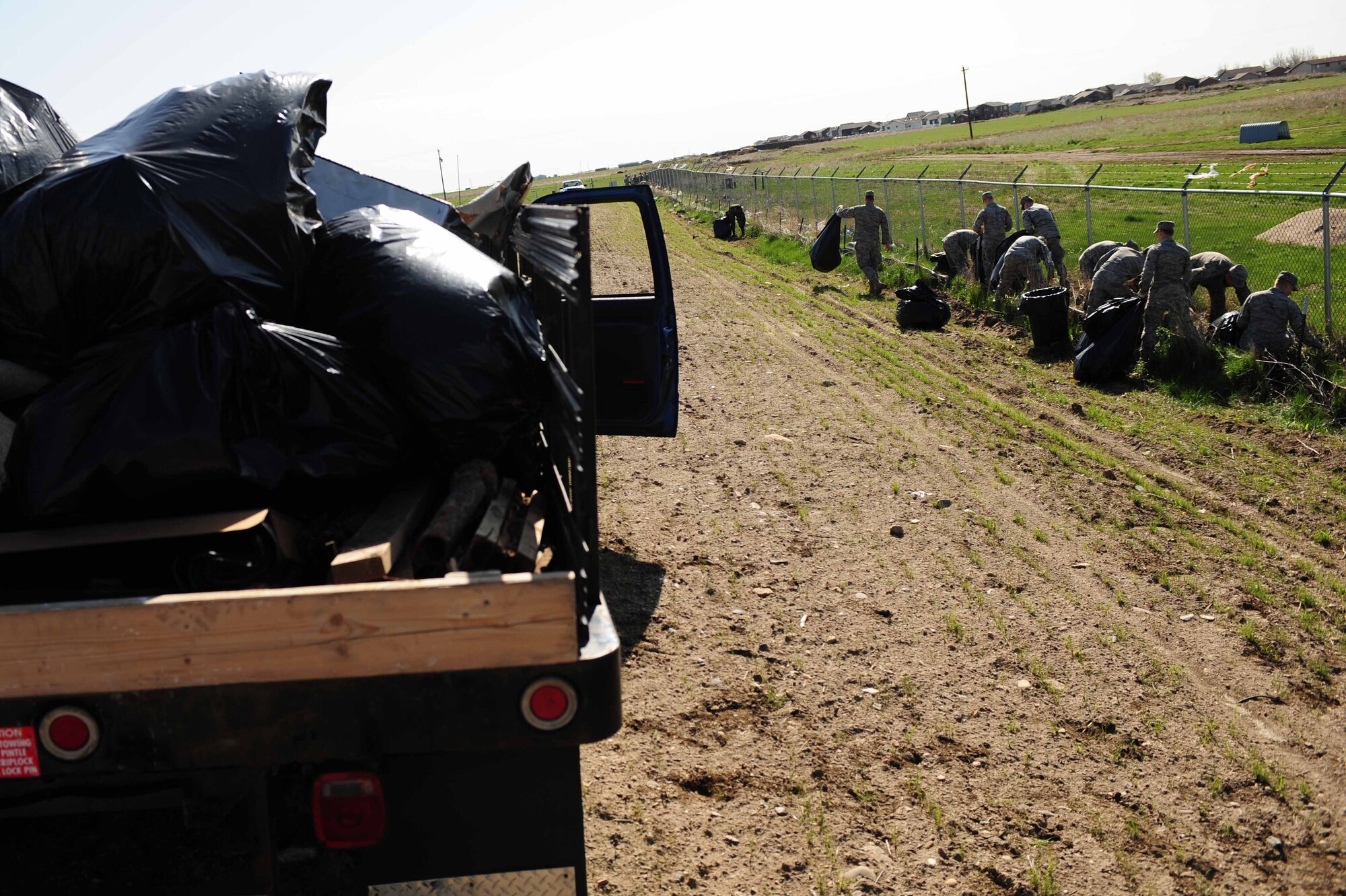 ELLSWORTH AIR FORCE BASE, S.D. -- Airmen pick up trash during a base cleanup, April 28.  The base cleanup’s theme was “spring cleaning” and it saved the Air Force $4,000 in contracting costs.  (U.S. Air Force photo/Airman 1st Class Corey Hook)