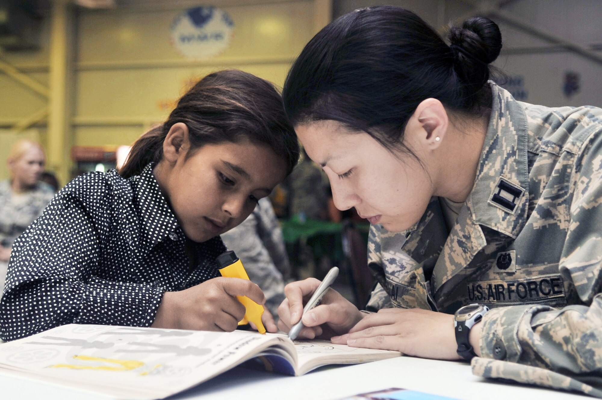 Capt. Erin Lai colors a picture with an Iraqi girl during Iraqi Kids Day April 24, 2010, at Joint Base Balad, Iraq. Captain Lai is a judge advocate with the 332nd Air Expeditionary Wing. (U.S. Air Force photo/Senior Airman Brittany Y. Bateman)