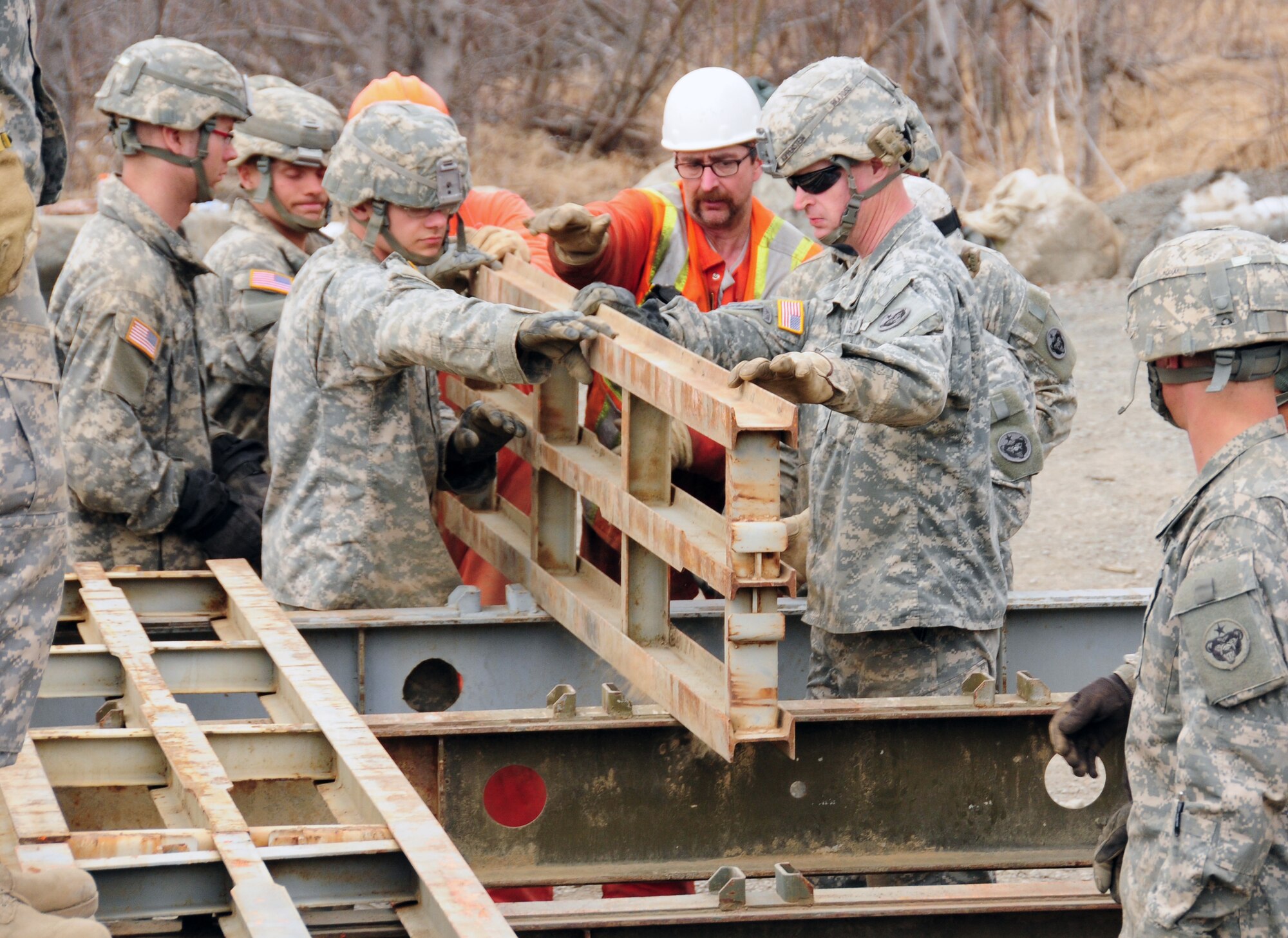 ANCHORAGE, Alaska -- Soldiers with the 56th Engineer Company, Fort Richardson, Alaska, and personnel from the Alaska Department of Transportation and Public Facilities move pieces during the assembly of an M2 Bailey Bridge during exercise Arctic Edge 10 April 28, 2010. As part of the exercise, the Soldiers and ADOTPF personnel worked to install the temporary bridge over Ship Creek northeast of Anchorage. (U.S. Air Force photo by Capt. Uriah Orland)