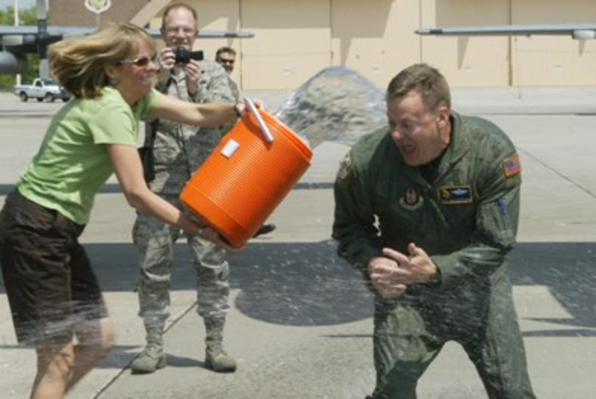 Senior Master Sgt. John L. Grutzmacher, Loadmaster from the 700th Airlift Squadron,  receives the traditional ice bucket wash down from his wife Ingrid after his final flight here Apr. 16. Grutzmacher has accepted a new assignment with the 96th Airlift Squadron, 934th Airlift Wing, Minneapolis Air Reserve Base, Minneapolis, Minn.