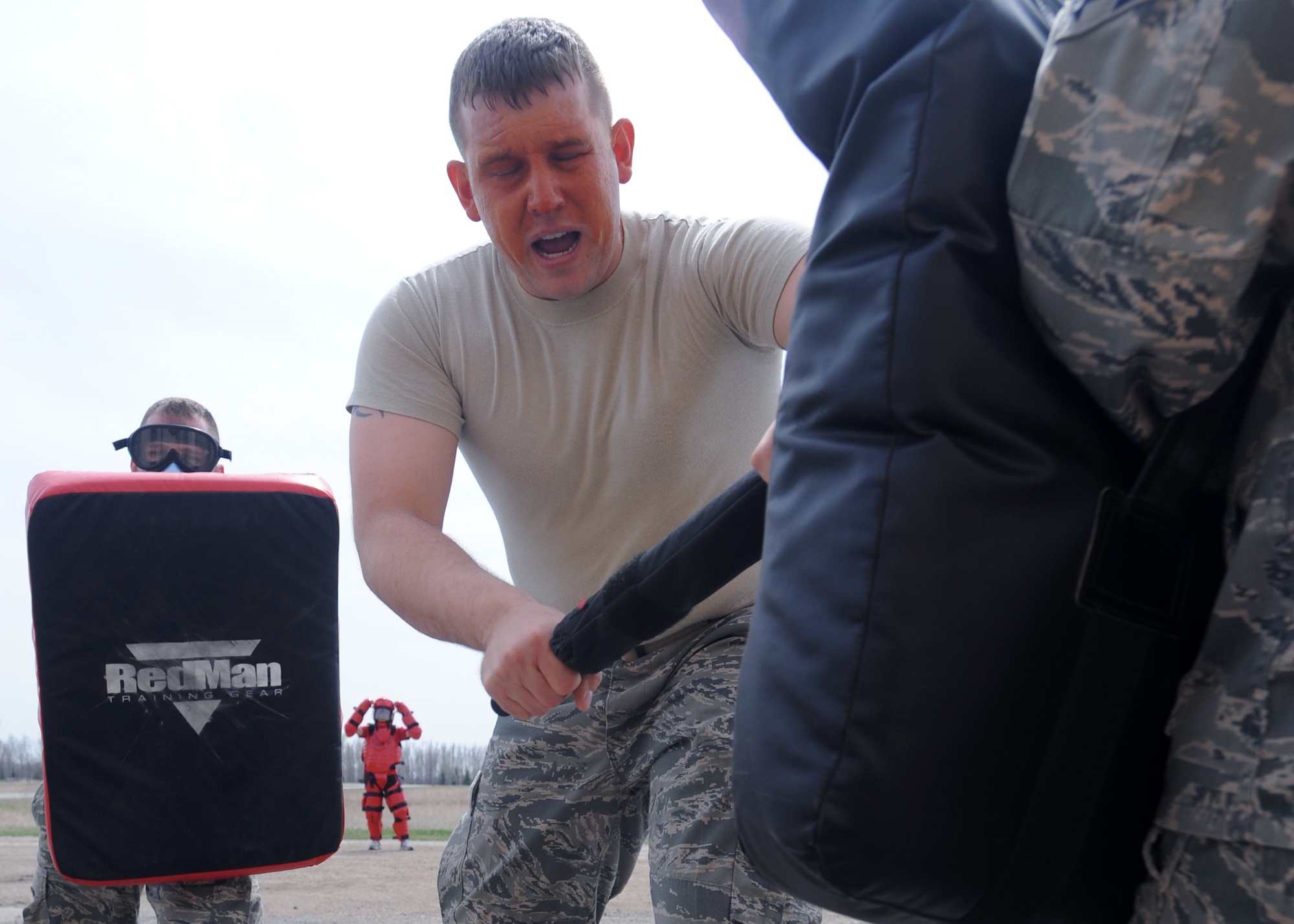 Senior Airman Richard Mulford, 319th Security Forces Squadron, performs combative drills after being exposed to oleoresin capsicum also known as pepper spray April 23 on Grand Forks Air Force Base, N.D.  Airman Mulford must be experienced with OC to be a certified handler. The Intra Service Non-Lethal Weapons training course serves two purposes, first, knowing what it’s like if exposed and second, knowing how to handle a suspect when exposed to OC. (U.S. Air Force photo by Airman 1st Class Amber Price)