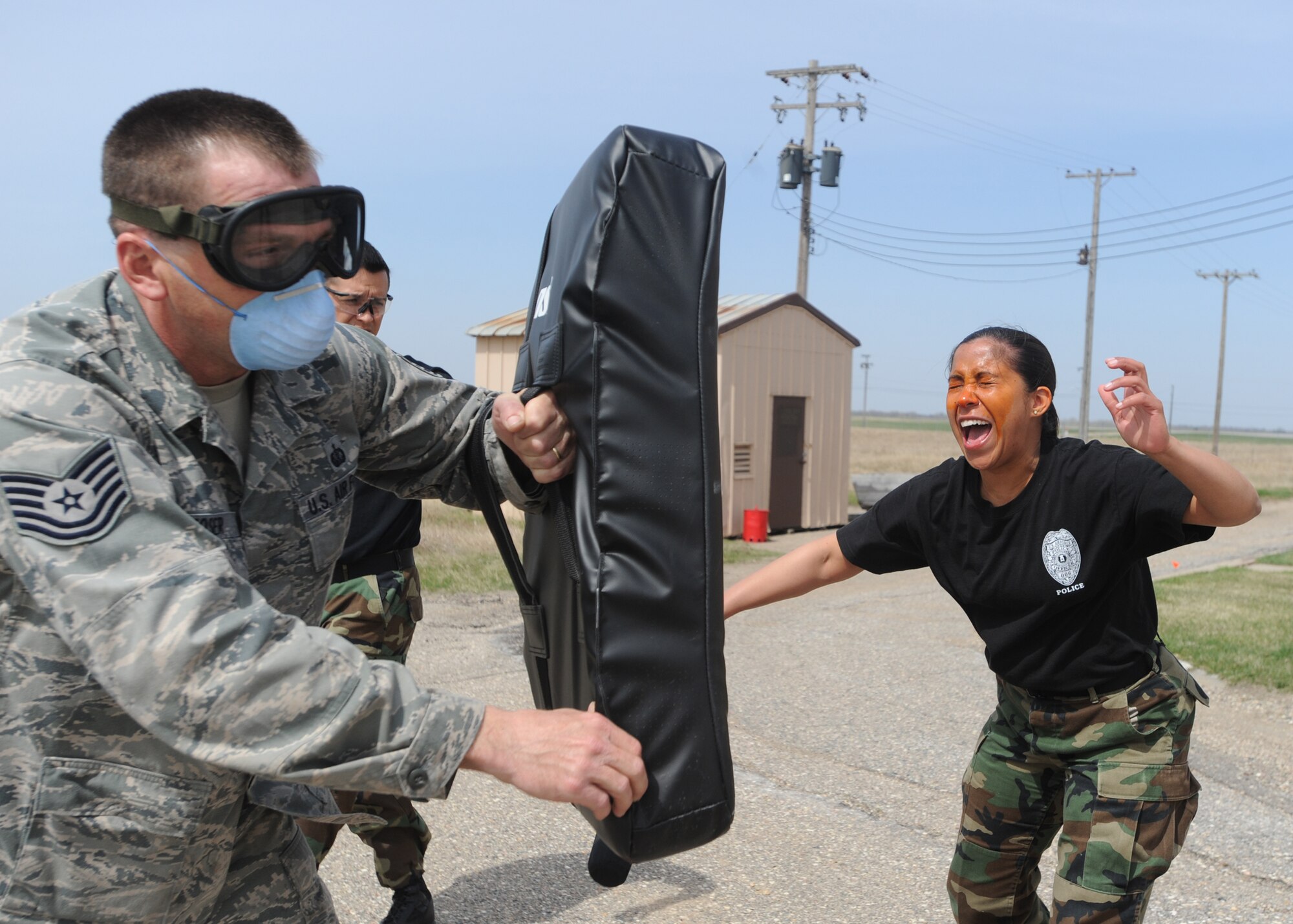 Kenia Koeltzow, 319th Security Forces Squadron Patrolman, performs combative drills after being exposed to oleoresin capsicum also known as pepper spray April 23 on Grand Forks Air Force Base, N.D.  Patrolman Koeltzow must be experienced with OC to be a certified handler. The Intra Service Non-Lethal Weapons training course serves two purposes, first, knowing what it’s like if exposed and second, knowing how to handle a suspect when exposed to OC. (U.S. Air Force photo by Airman 1st Class Amber Price)