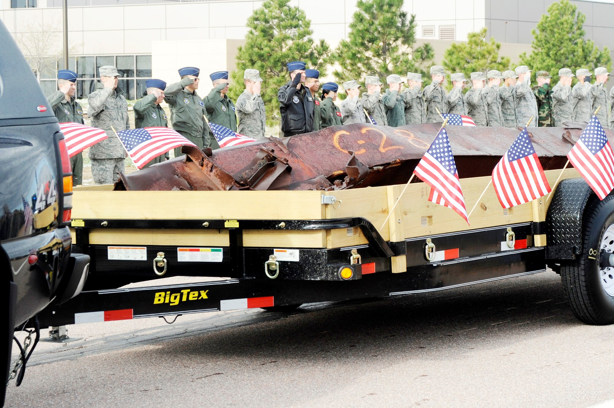 Airmen salute during the arrival of a beam from one of the collapsed towers of the World Trade Center April 26, 2010, at Schriever Air Force Base, Colo. The beam was donated to become part of a memorial on base to commemorate the events of Sept. 11, 2001. (U.S. Air Force photo/David Ahlschwede)
