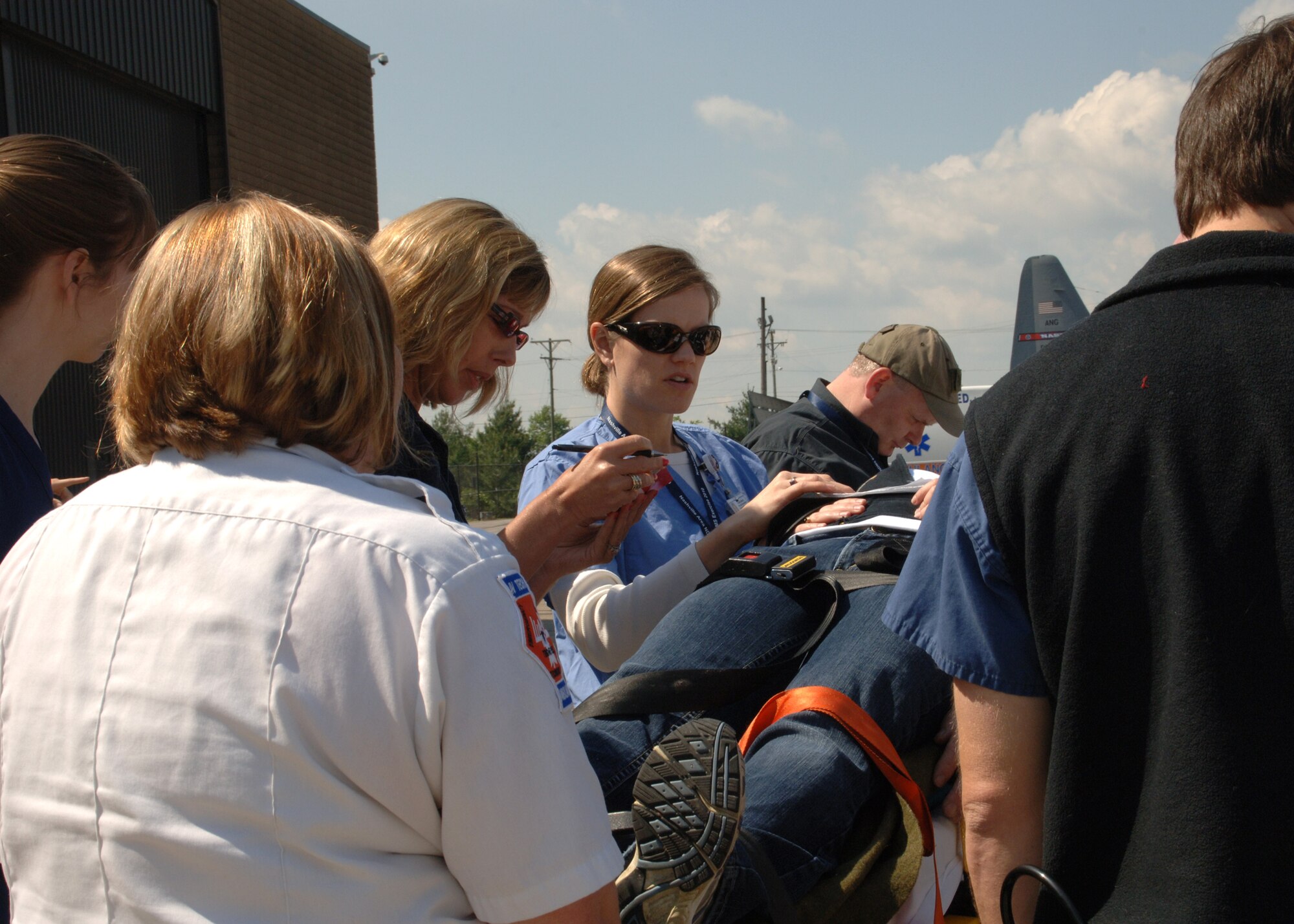 A nurse checks out a patient being received off of the aircraft during the National Disaster Medical System exercise at the 118th Airlift Wing, April 28. 