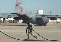 Staff Sgt. Abdul Ganeu Abdulai, a C-130 Hercules crew chief, races back to a Modular Airborne Firefighting System "pit" April 28 during the 2010 Modular Airborne Firefighting System certification training in Greenville, S.C. Maintenance and ground crews involved with MAFFS support several missions when aircraft return from a fire, including aircraft power generation, refueling and rearming with fire retardant or pressurized water. The annually-held certification brought together more than 400 Air National Guard and Air Force Reserve Airmen and their unit's C-130s to receive certification from the U.S. Forest Service in aerial firefighting. The certification runs April 25-May 1. Sergeant Abdulai is assigned to the Air Force Reserve's 302nd Airlift Wing. (U.S. Air Force photo/Staff Sgt. Stephen J. Collier)